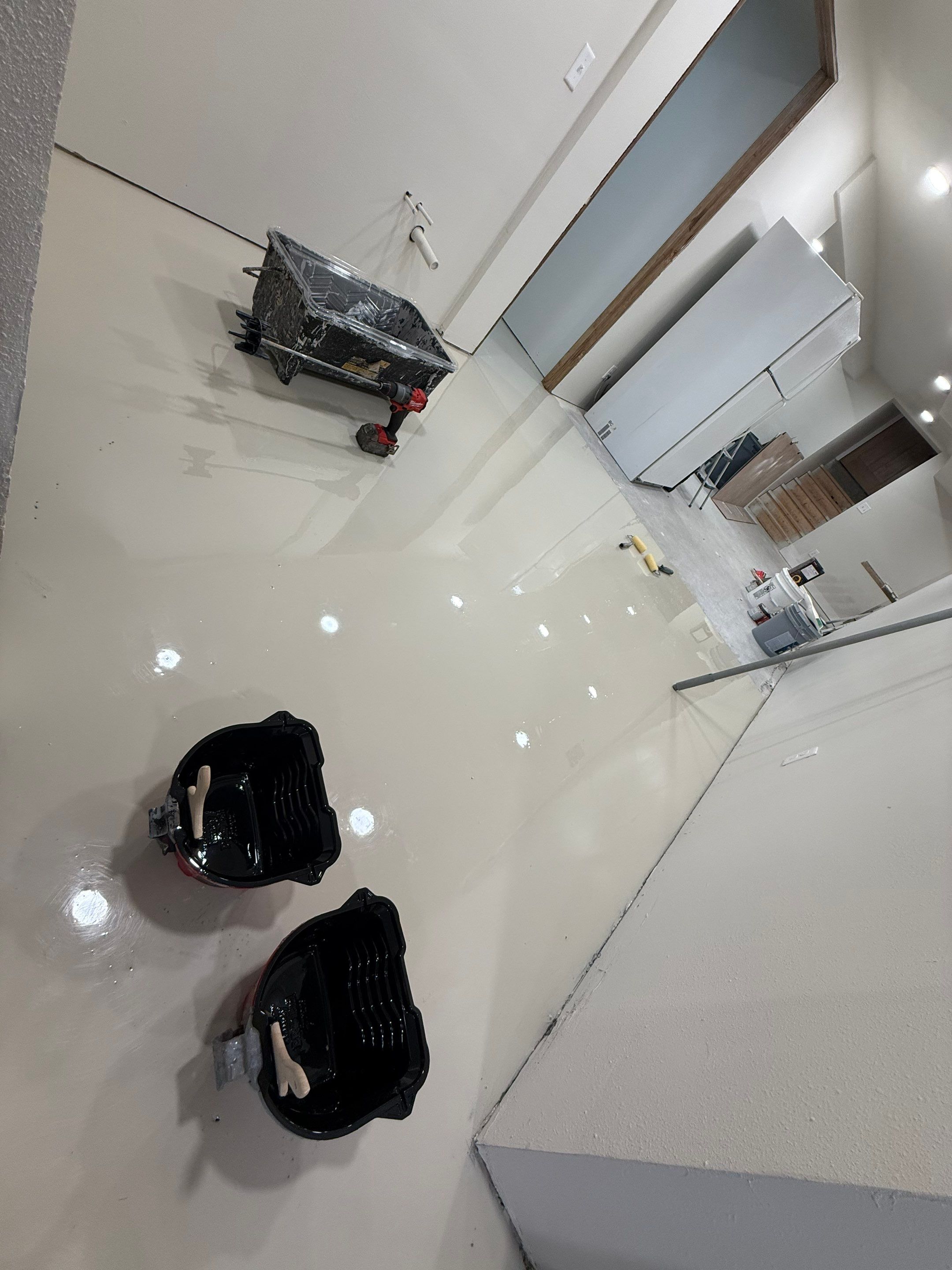 High-Gloss Epoxy Floor Coating and Basement Renovation in Rock Rapids by Select Painting, Coatings & Garage Cabinets