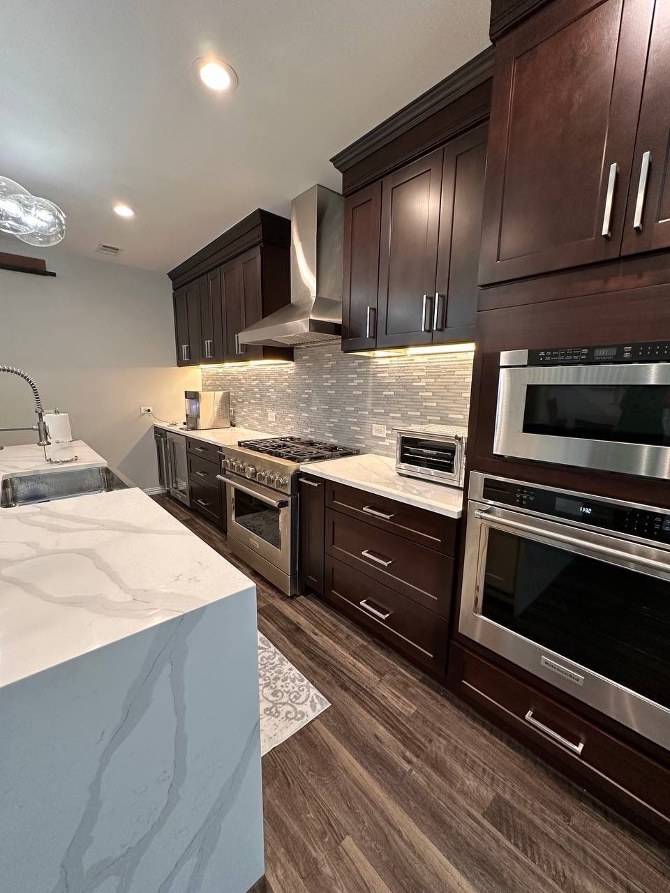 Kitchen Remodel using Calacata Quartz by Construction Nation Group