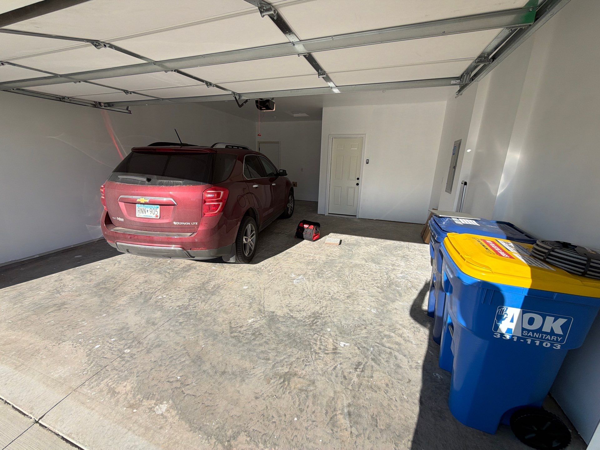 Sioux Falls Garage Floor Transformation with Cabin Fever Decorative Chips by Select Painting, Coatings & Garage Cabinets