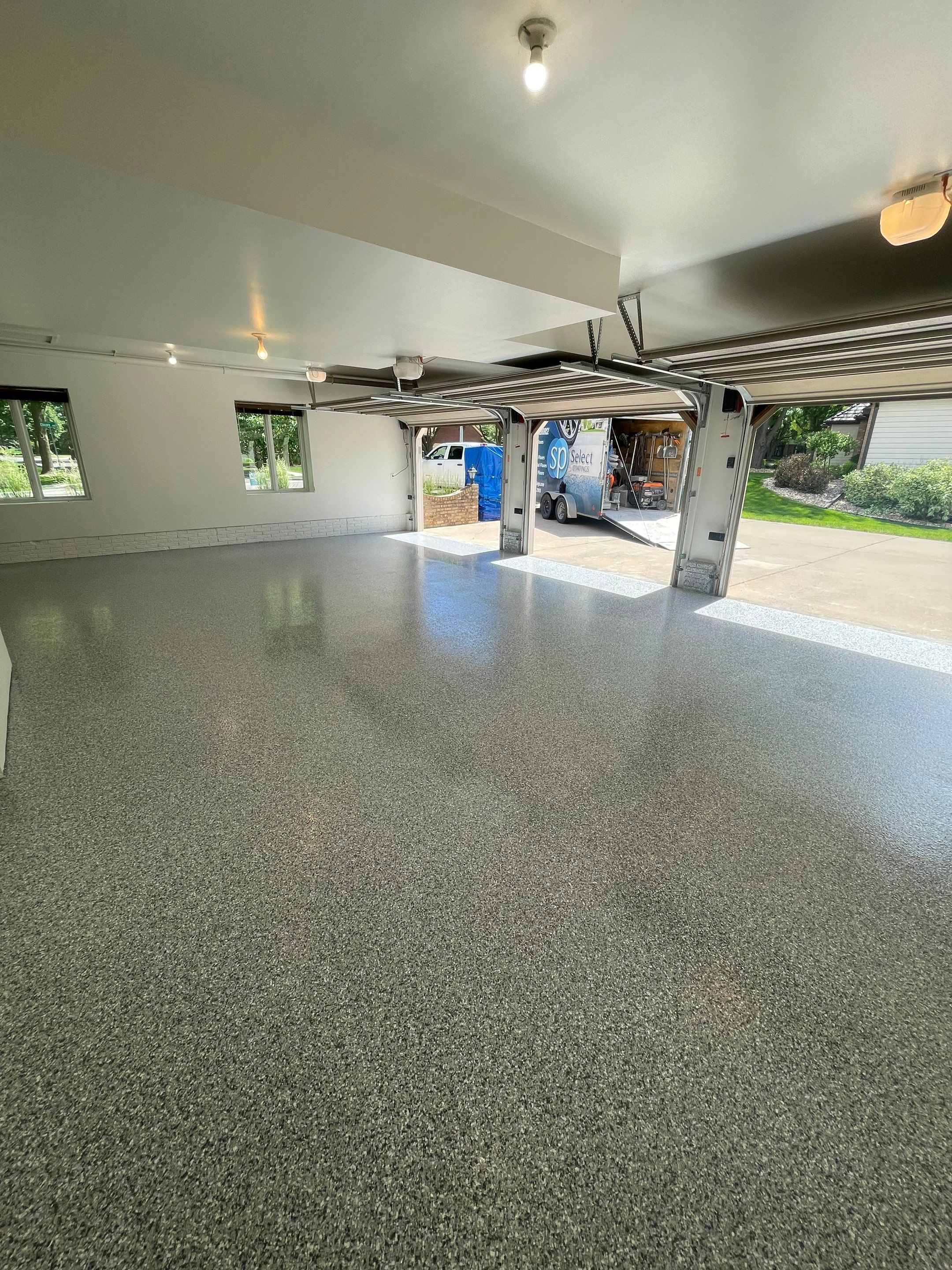 Gray Speckled Epoxy Garage Floor Coating in Sioux Falls by Select Painting, Coatings & Garage Cabinets