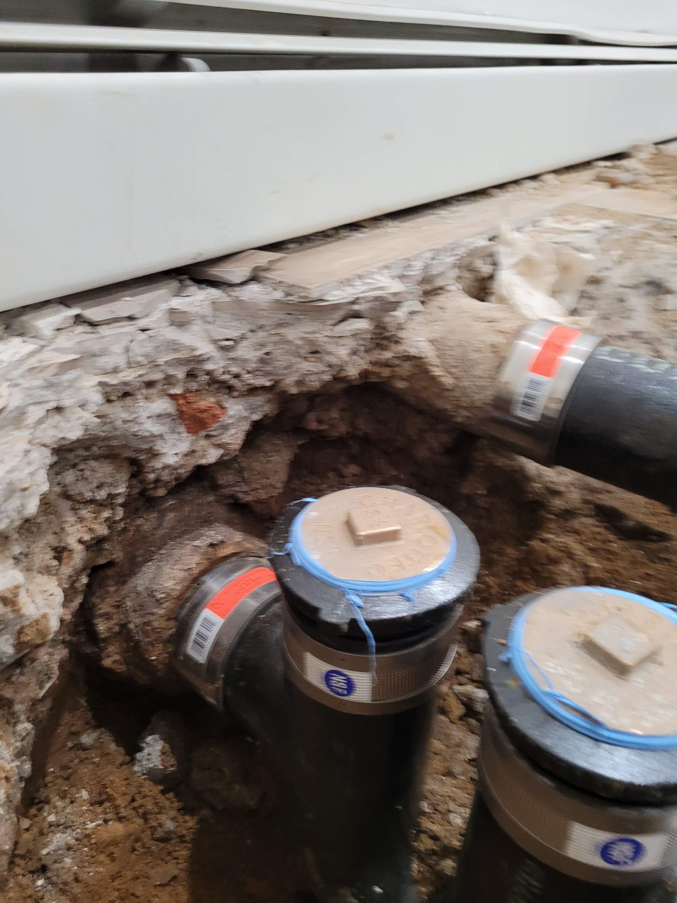 The replacement of a crumbing leaky house u-trap in basement by WG's Remodeling Inc