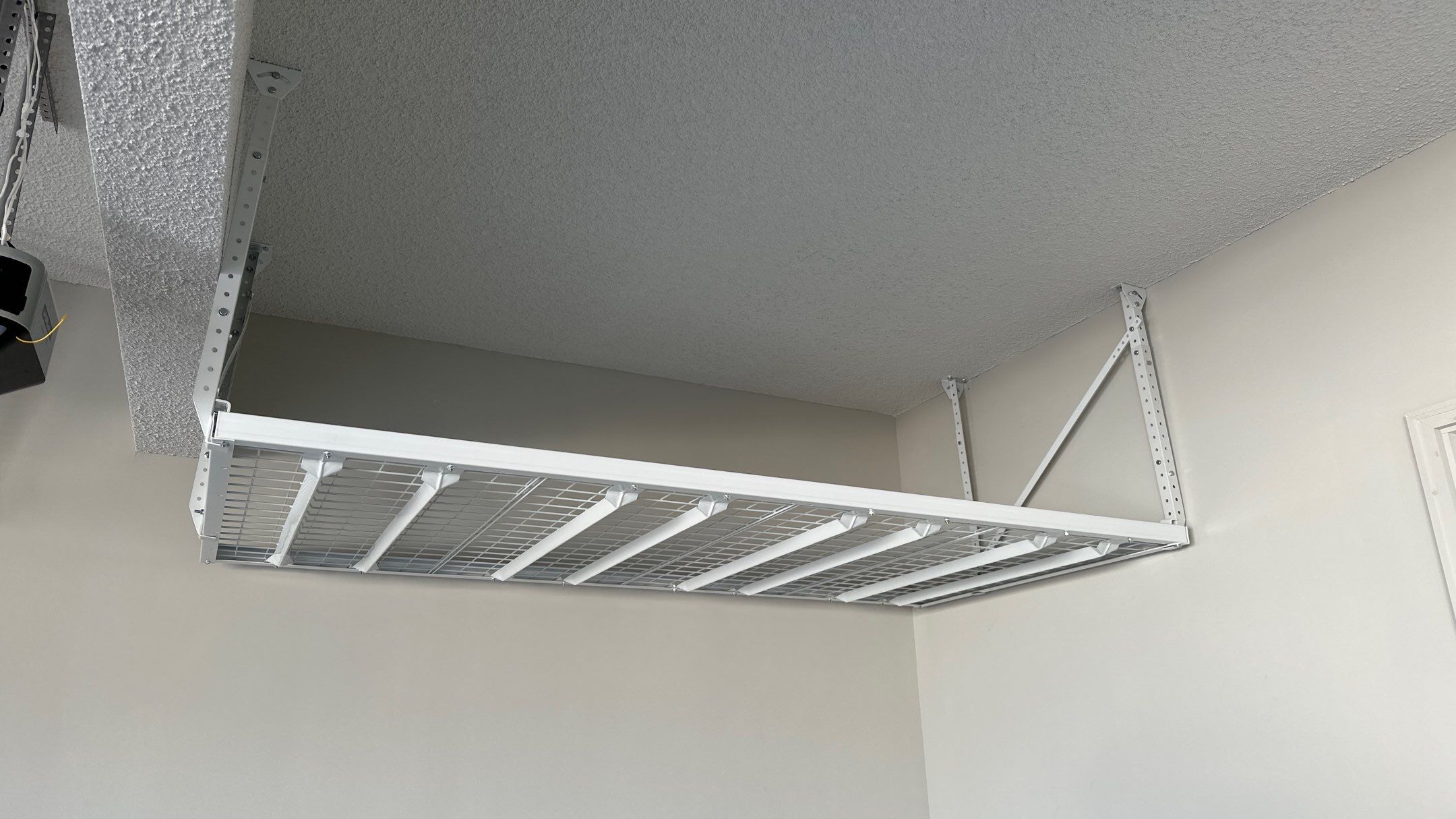 Brandon C. added these overhead racks to upgrade his storage  by Banner Garage