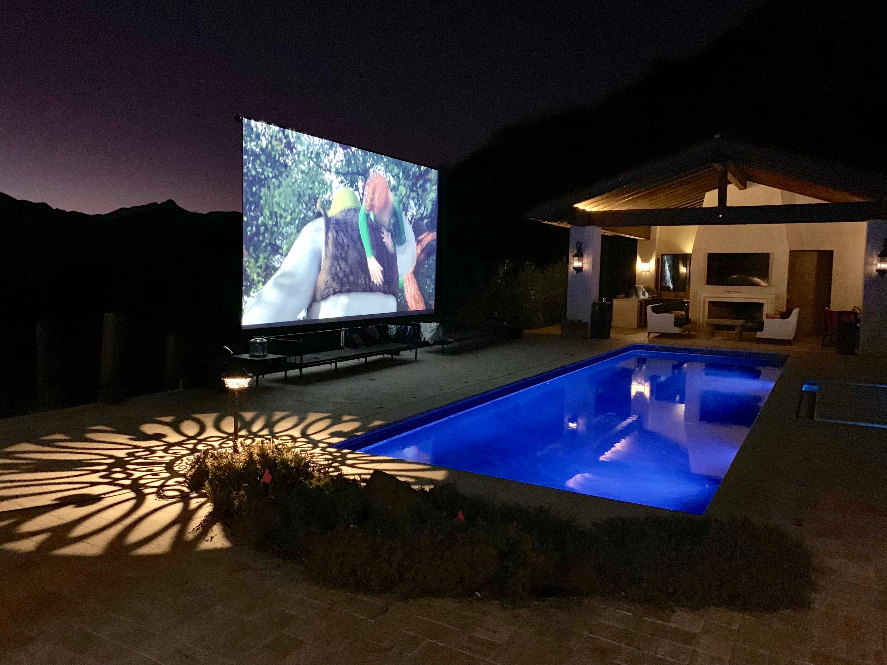 Malibu Hillside Outdoor Living Space with Custom Landscape Lighting + Surround Sound System by Outdoor Lights + Shades
