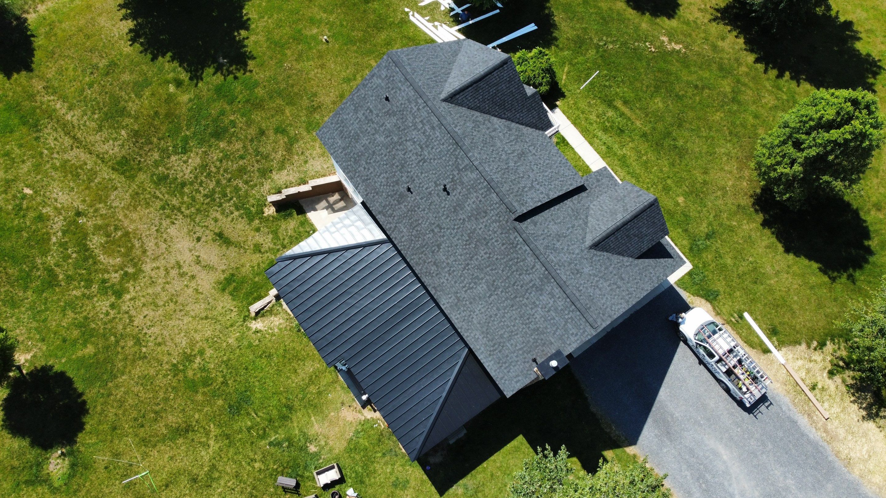 Roof Damage using Certainteed Lifetime Roofing System- Moire Black Landmark Pro shingkes with shadow ridge caps. by BulletpROOF Exteriors