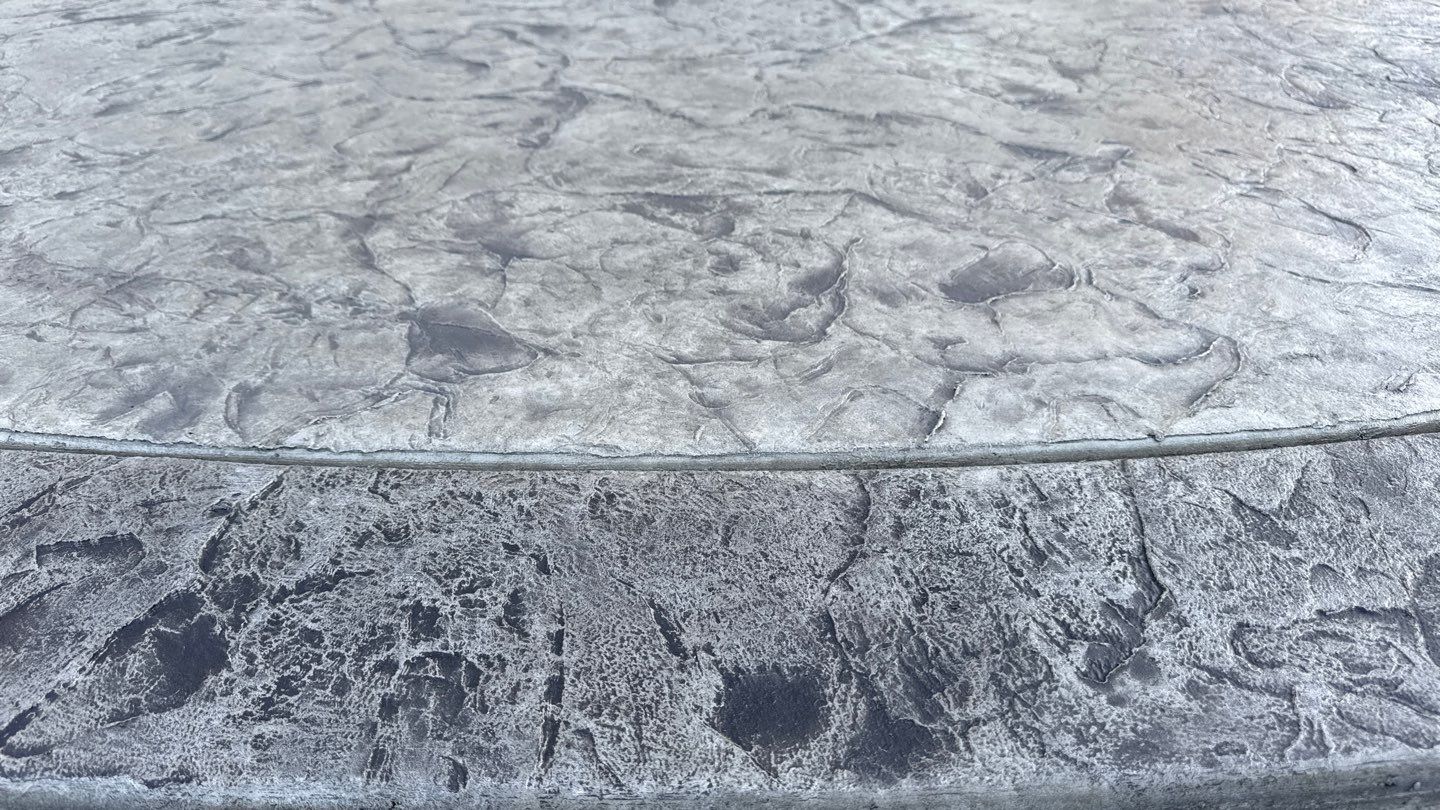 Oxford slate stamped concrete patio  by NG Masonry & Construction LLC