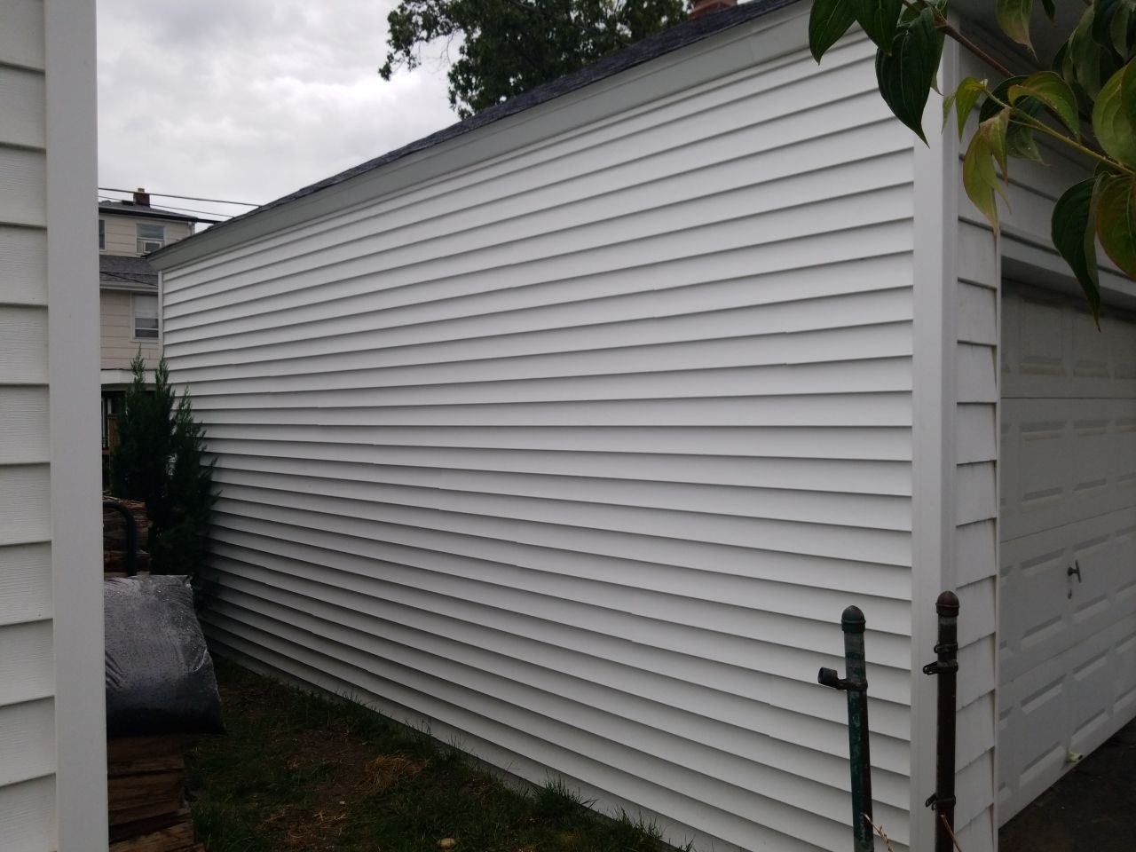 Residential Roofing Installation, Dec-tek walk-out porch roof, siding on garage by Absolute Roofing and Construction