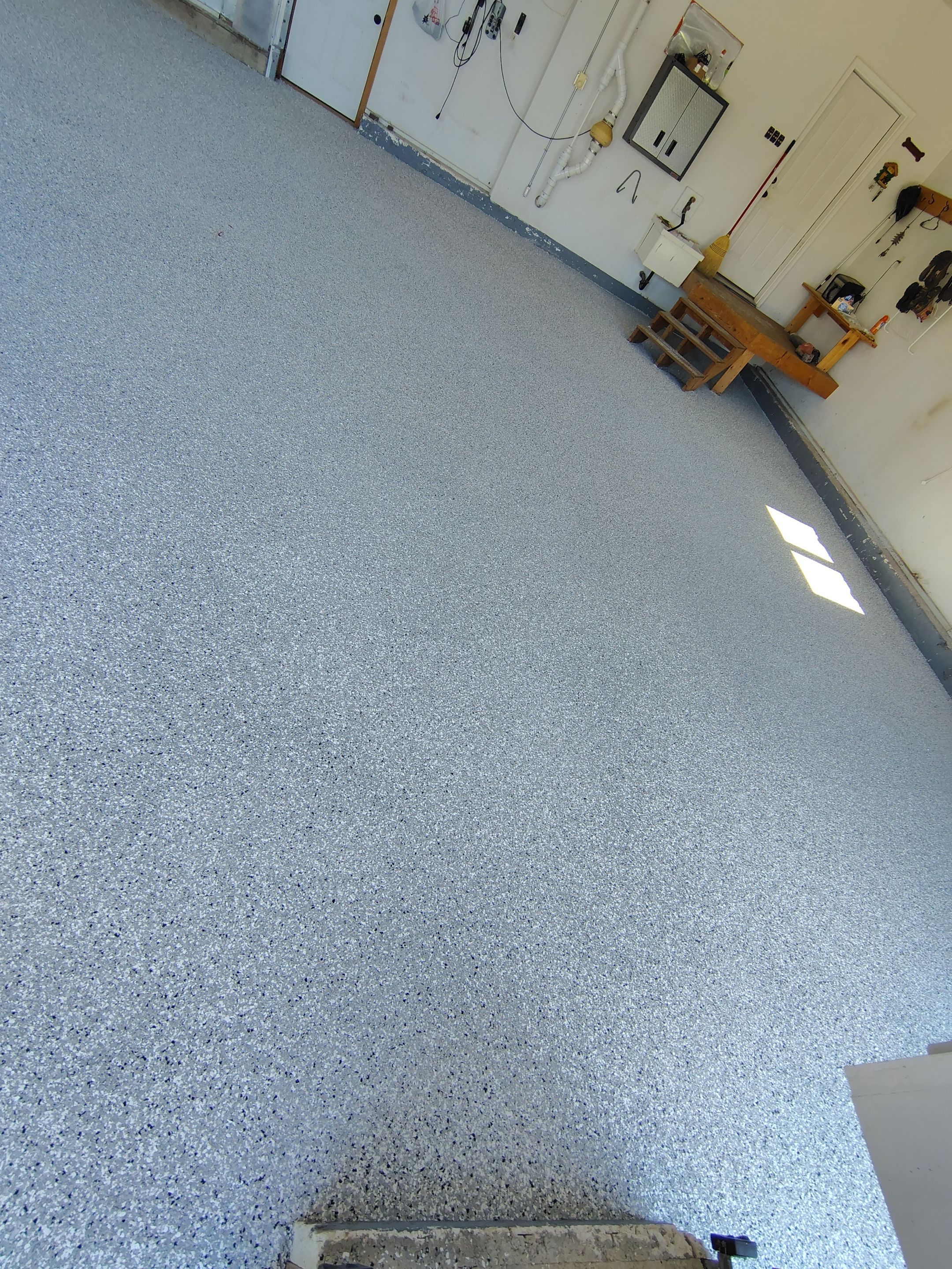 Feather Grey Garage Floor Coating Installation in Valley Springs by Select Painting, Coatings & Garage Cabinets