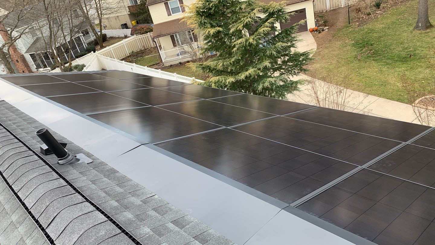 Roof Replacement with GAF Decotech integrated solar panels by American Home Contractors