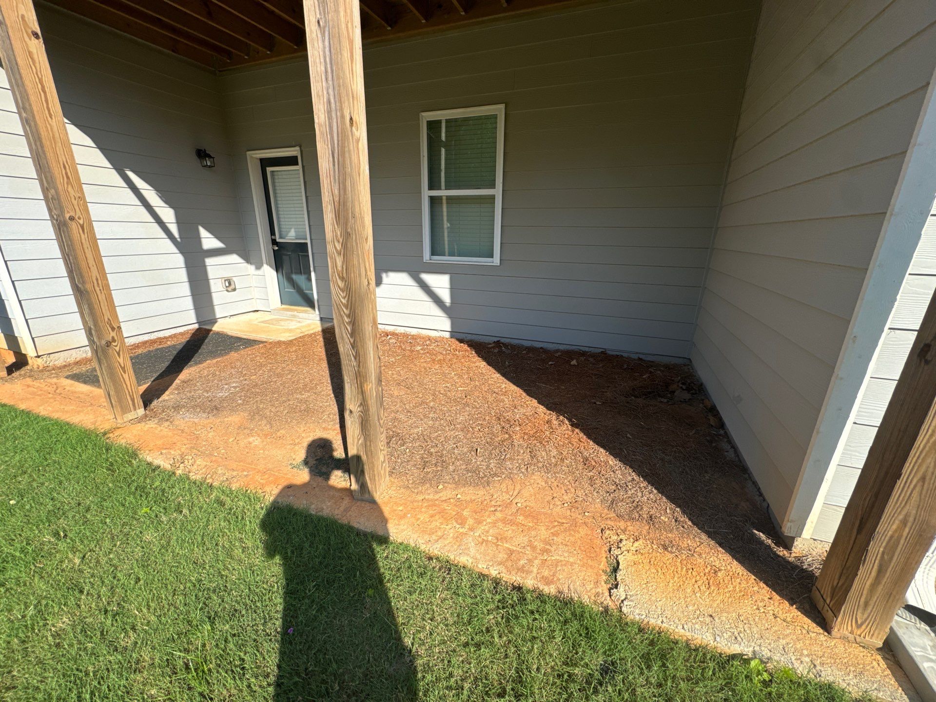 Ground-Level Gray Composite Deck and Privacy Fence Installation by Swift Home Renovations
