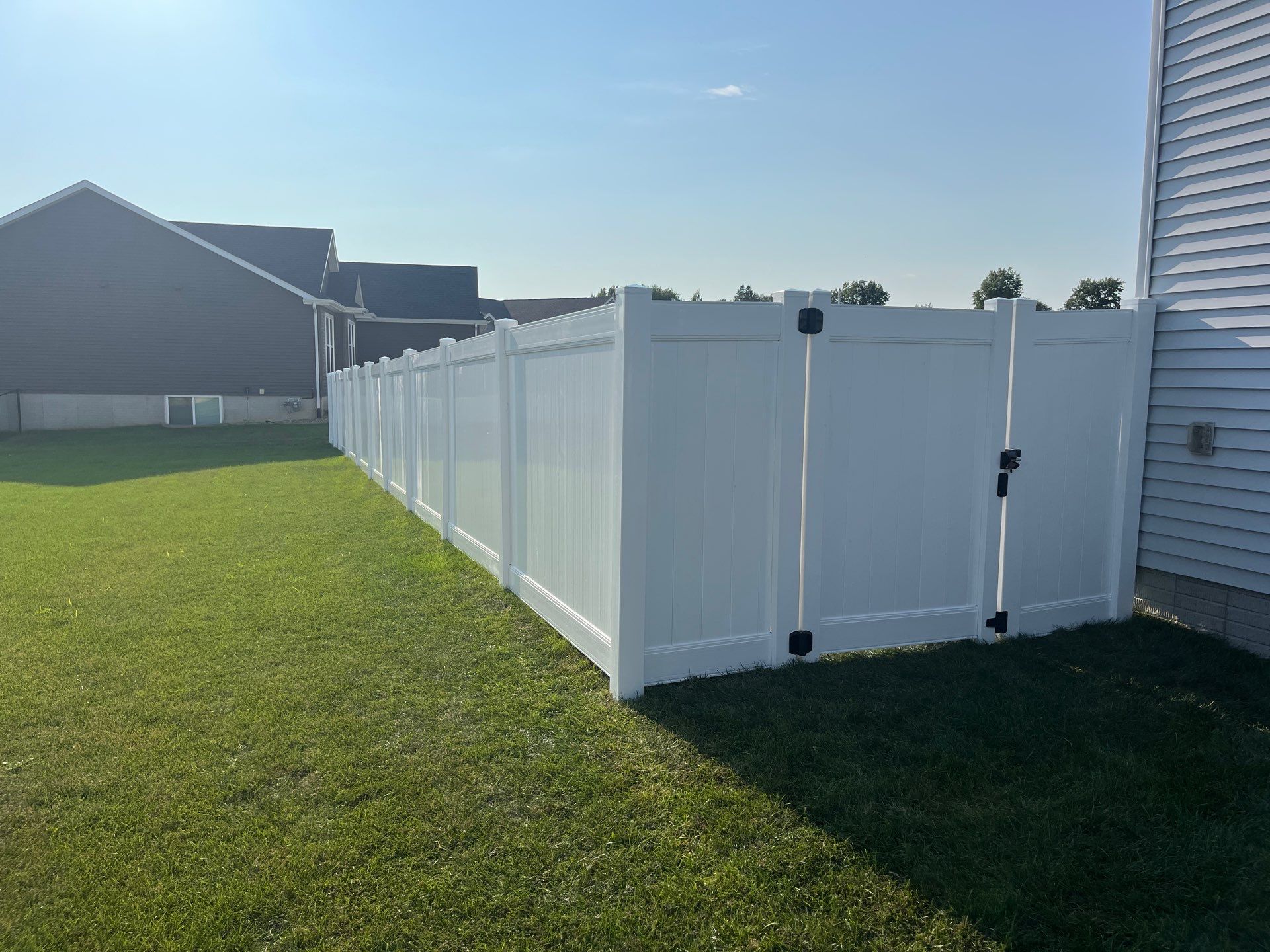 White Vinyl Privacy Fence Installation With Double Gates in Waterloo by Perfect Picket Fence and Stain