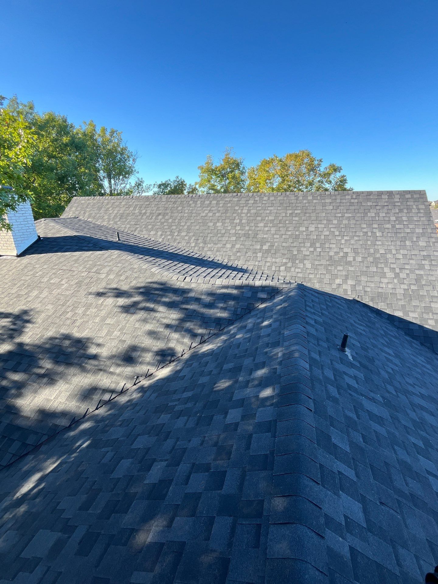 White brick with IKO Granite Black by Tejas Roofworks + Restoration