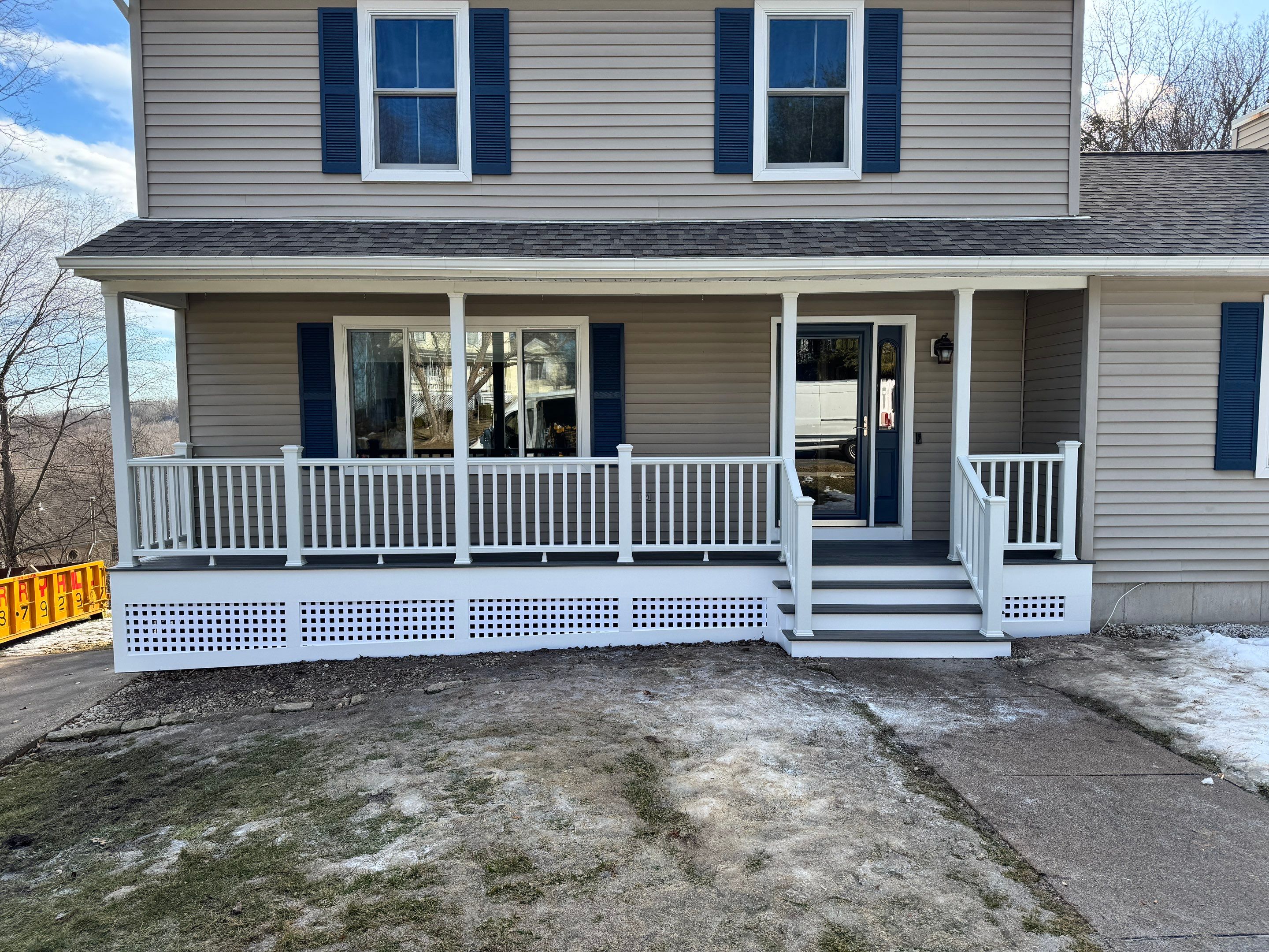 Replacement front porch using Trex Tropical Island mist and White composite railings. Includes lattice bottom. by DiGiorgi Roofing and Siding Inc