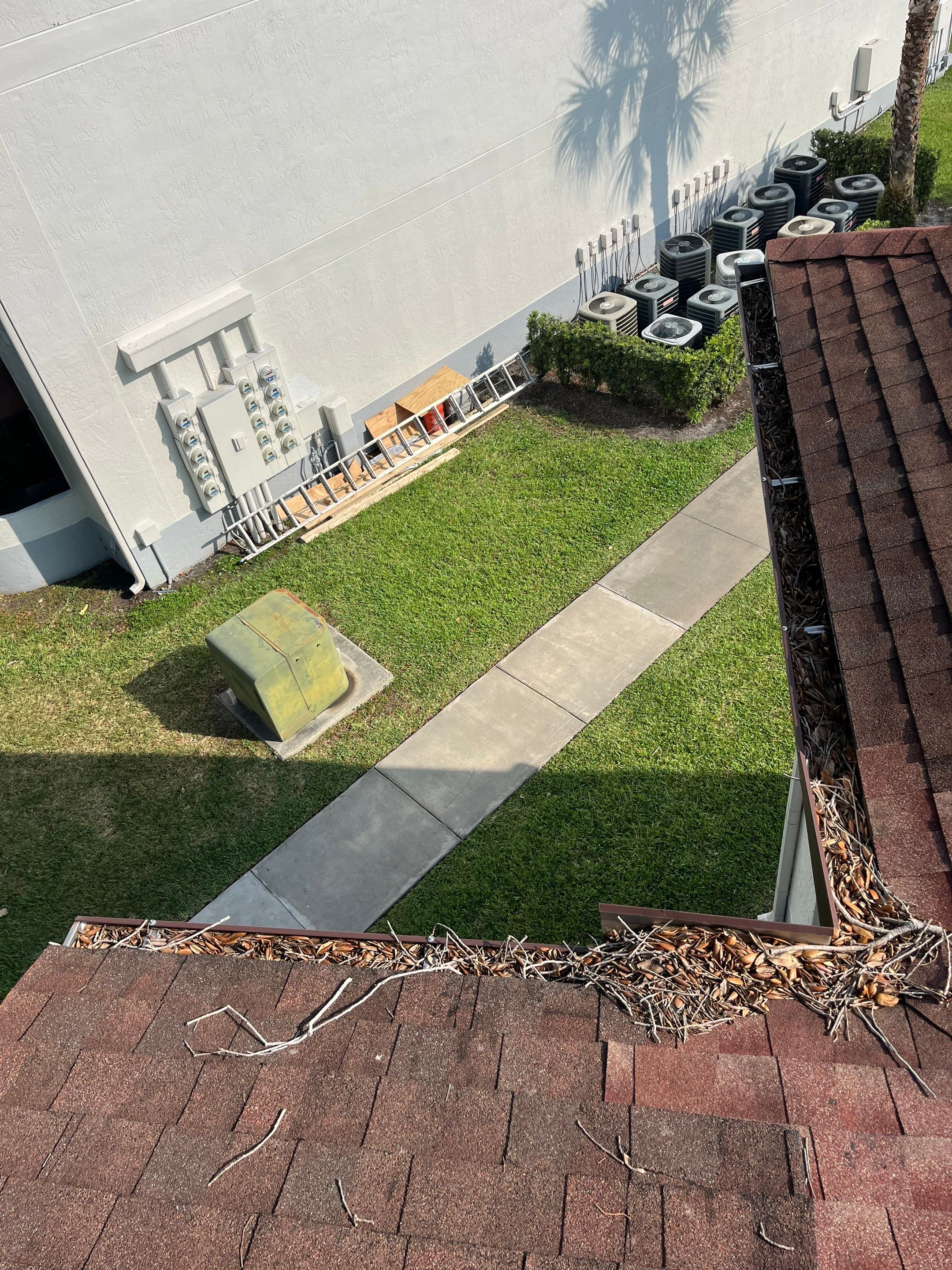 Commercial gutter cleaning Miami & Fort Lauderdale before photo with filled gutters
