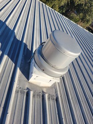 Completed metal roof with white vent cap
