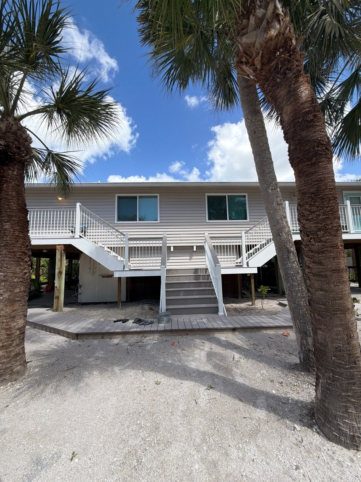Elevated Home Deck Reconstruction With White Aluminum Railings in Placida by Smirnov Construction Inc