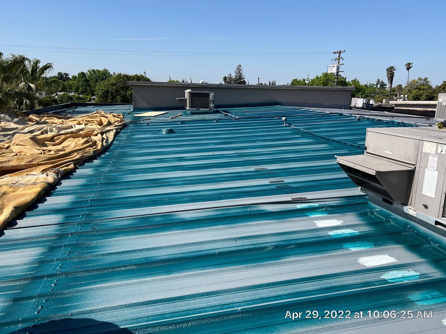 Metal roof restoration on commercial roof using Conklin Benchmark/ PUMA XL acrylic coatings over metal and foam by Straight Edge Roofing Inc