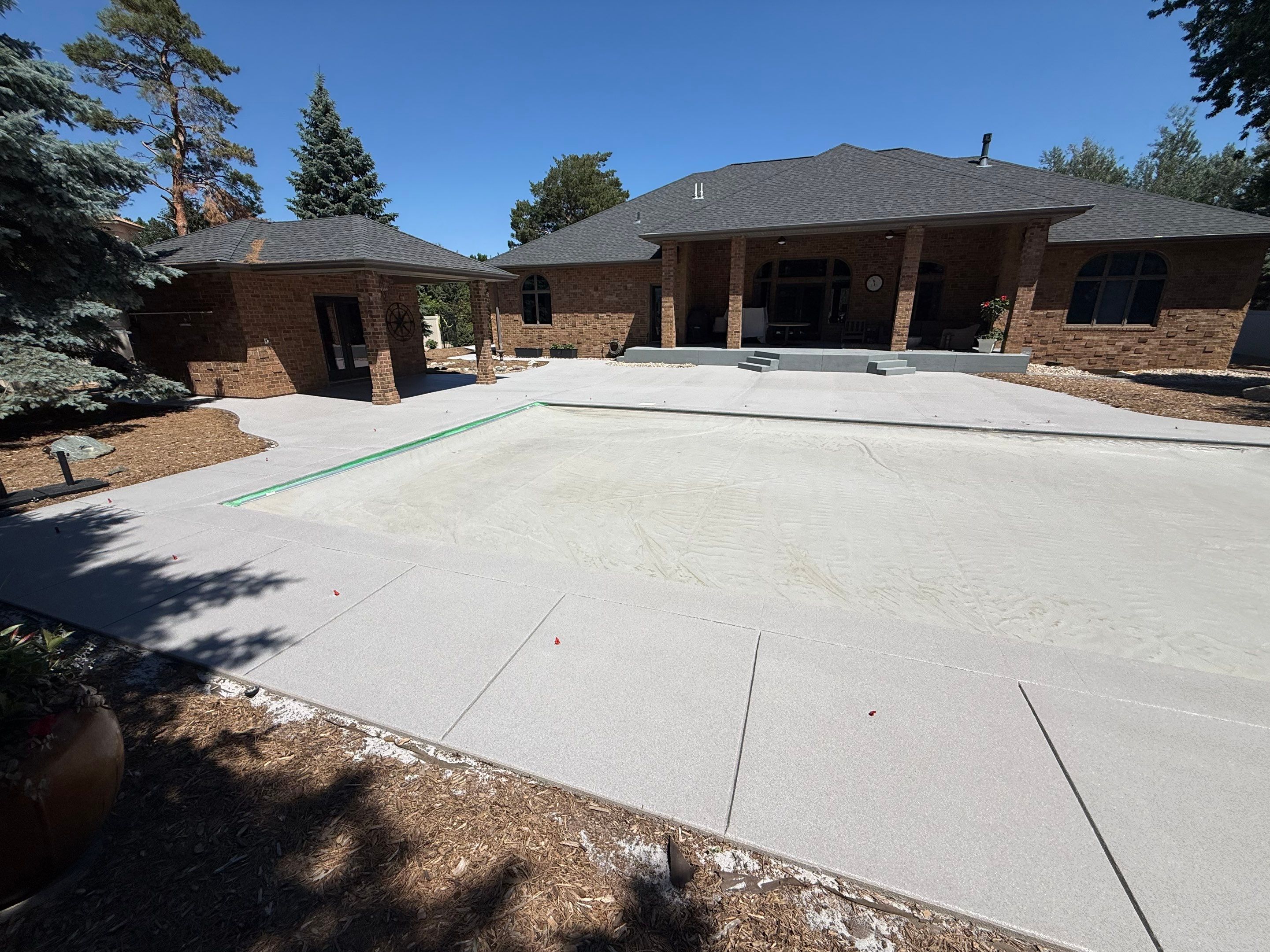 Decorative Concrete Pool Deck and Patio Resurfacing in Sioux Falls by Select Painting, Coatings & Garage Cabinets