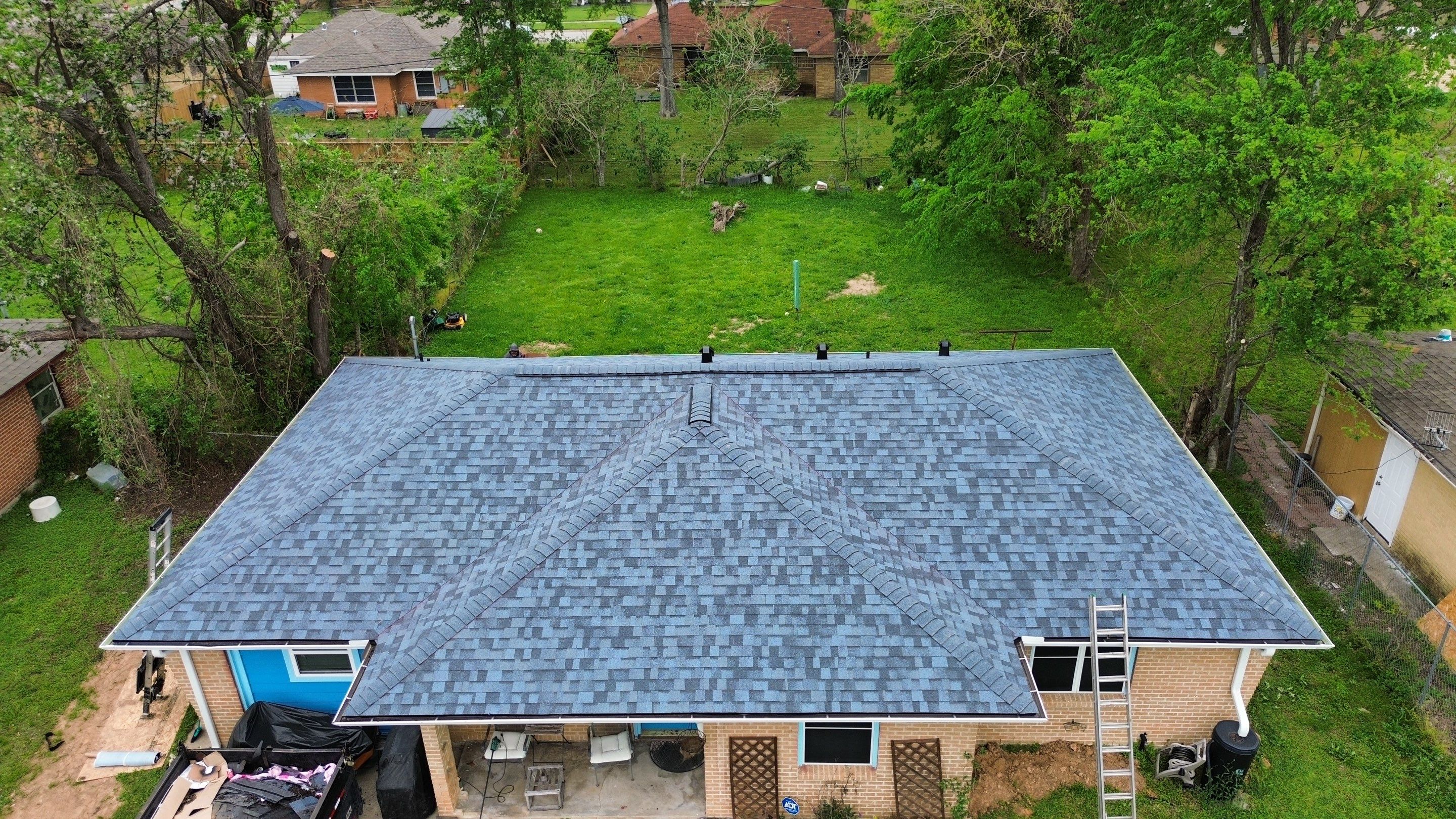 Houston Residential Roof Replacement Using Harbor Blue Architectural Shingles by Houston Roofing & Construction