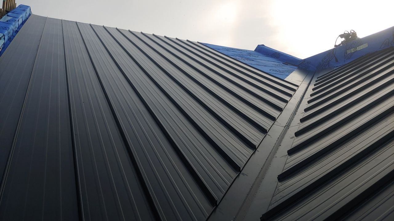 Commercial Roofing Installation using 12" Prolok metal and hidden gutters! by Top Notch Roofing Inc