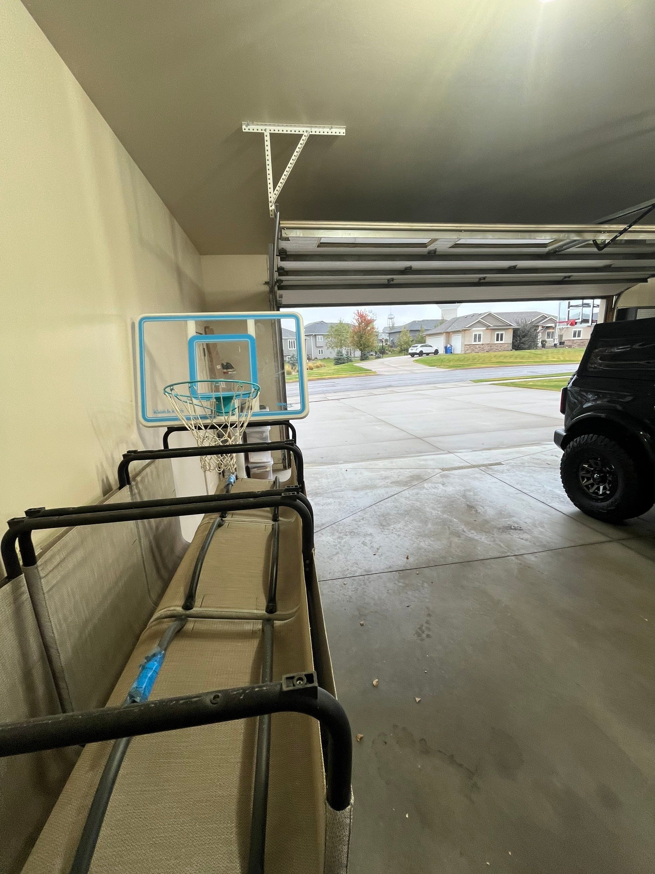 Coyote Flake Garage Floor Coating in Sioux Falls with Trench Drain by Select Painting, Coatings & Garage Cabinets