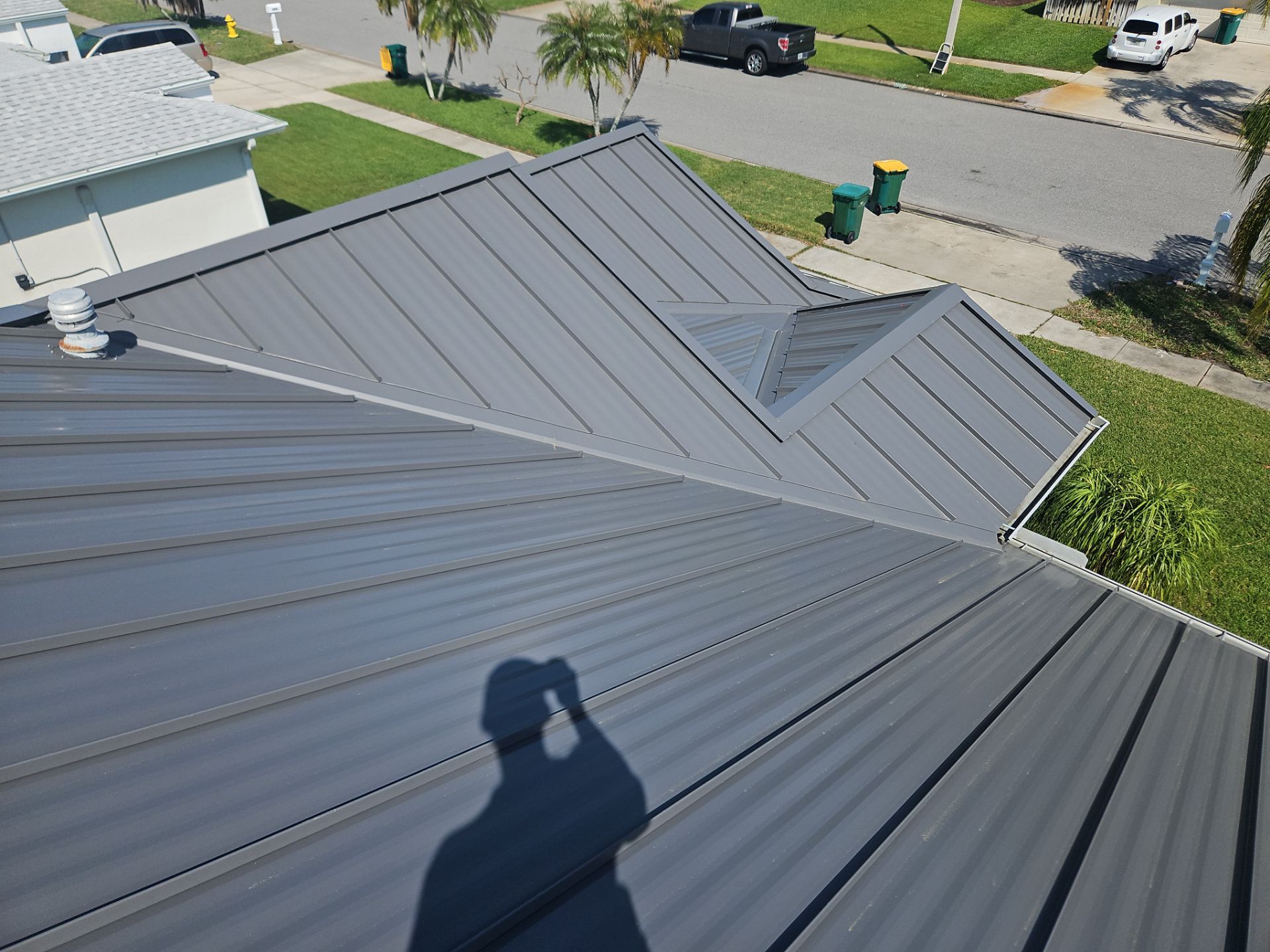 Complete Metal Roof Replacement and Seamless Gutter Installation in Melbourne by Wiedmann Construction & Roofing