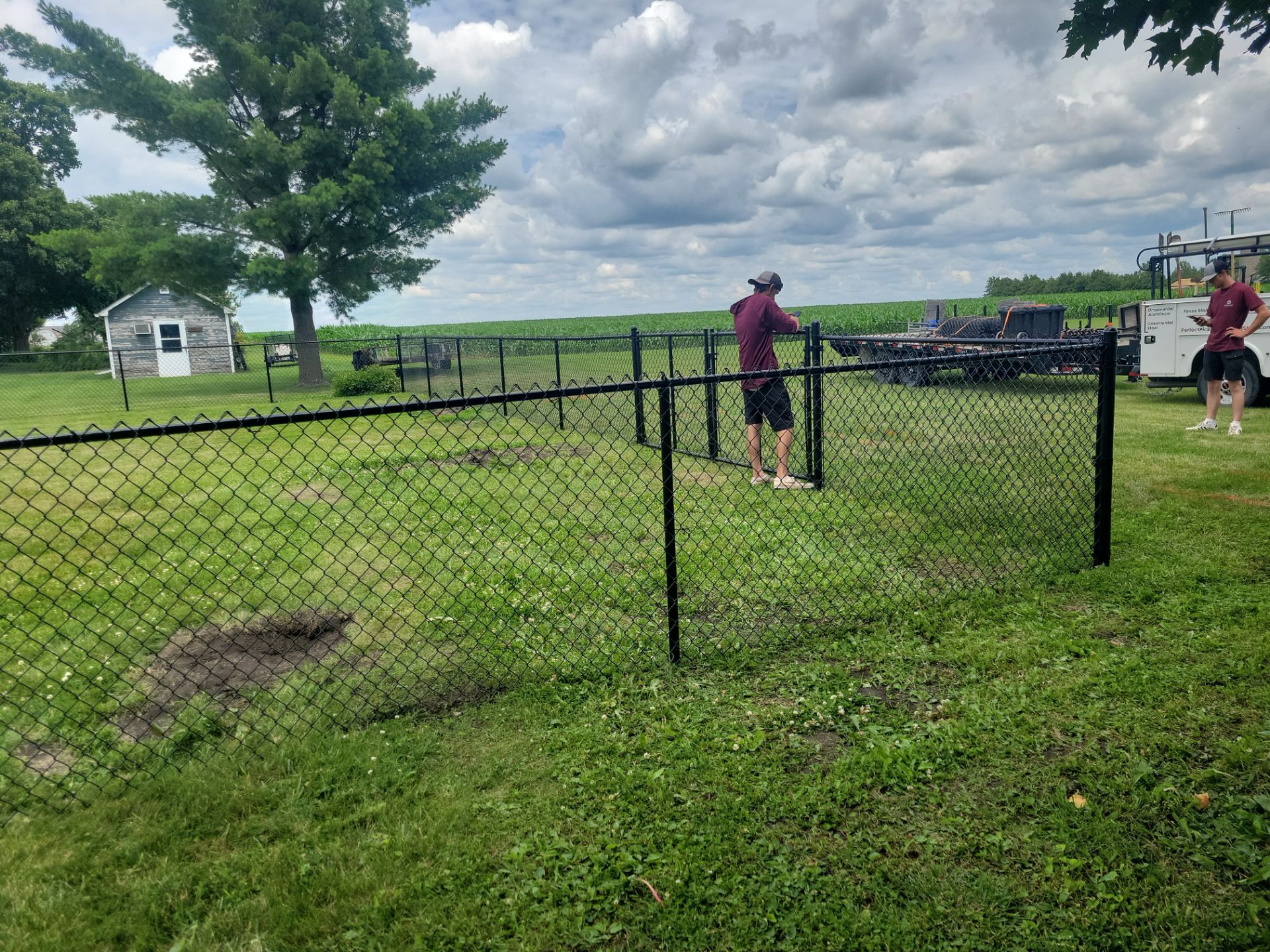 Residential Black Vinyl-Coated Chain Link Fence Installation in Allison by Perfect Picket Fence and Stain