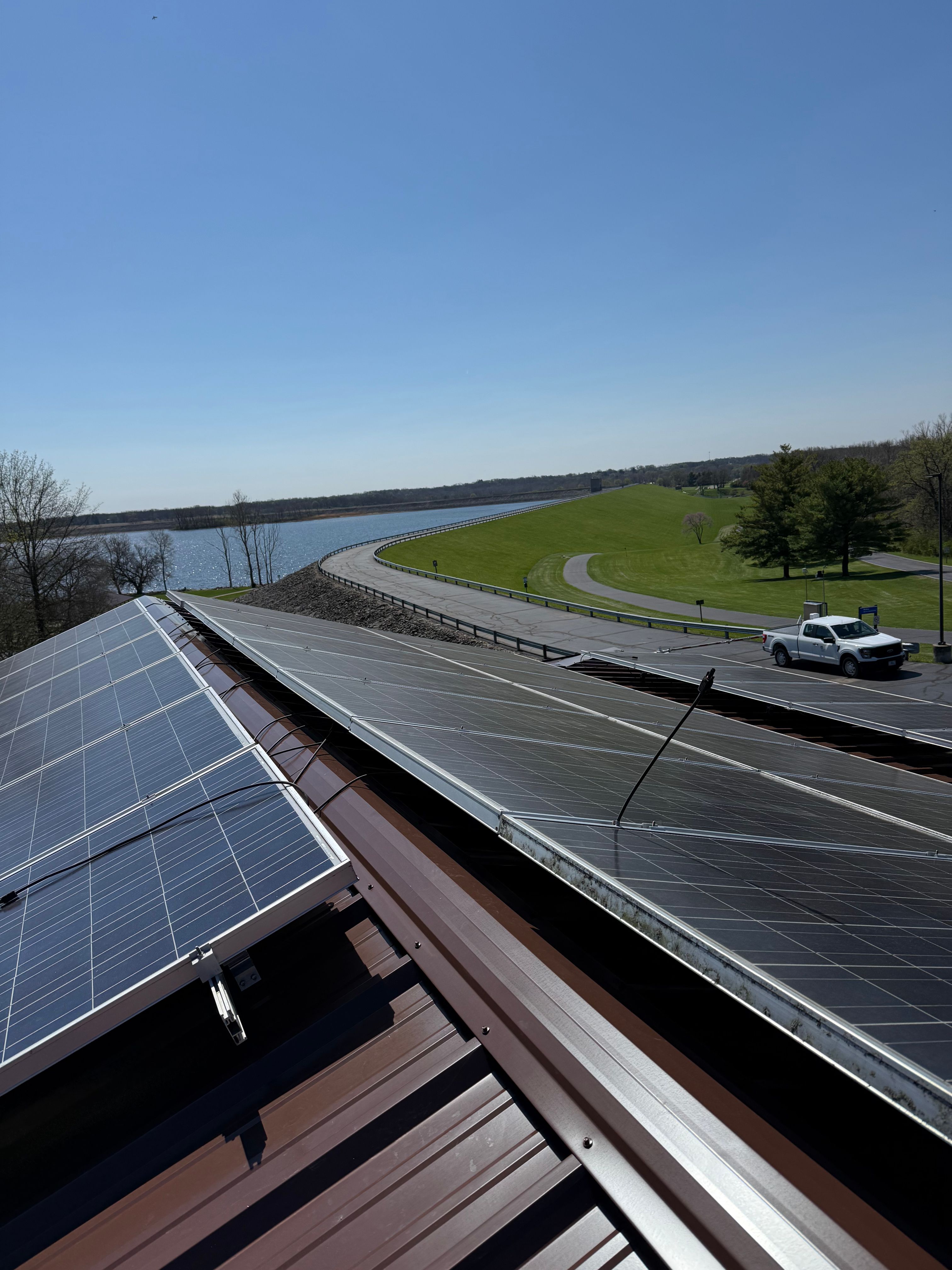 Brown R-Panel metal roof with solar by Atlas Roofing & Restoration