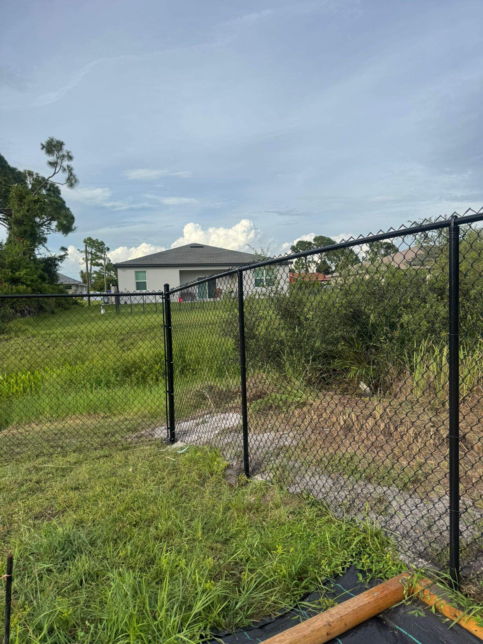 Black Vinyl-Coated Chain Link Fence and Gate Installation in North Port by True Fence LLC