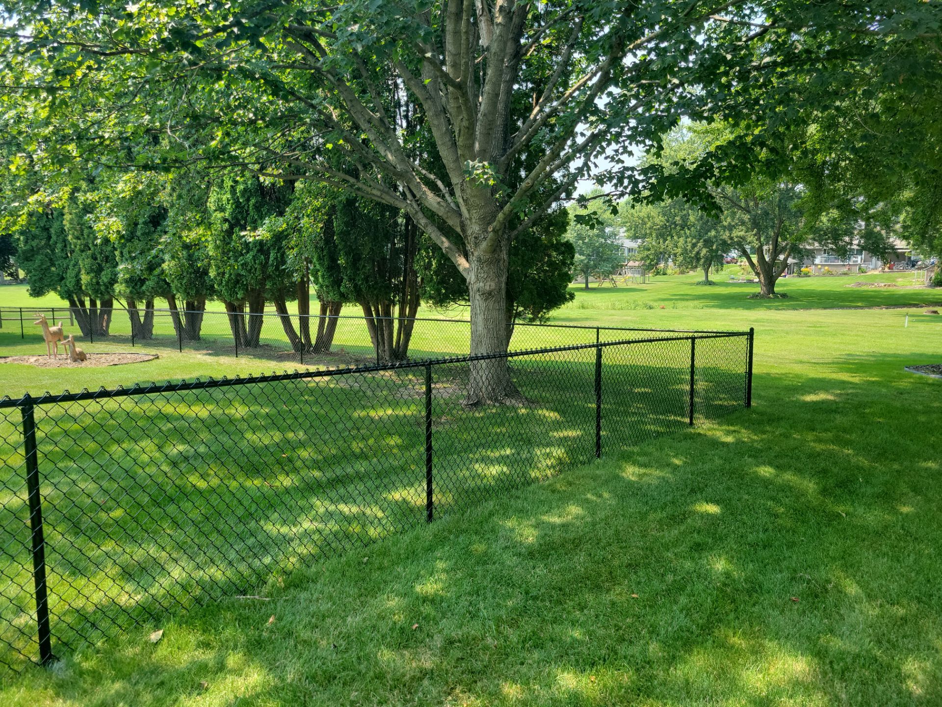 Black Vinyl-Coated Chain Link Fence Installation in New Hampton by Perfect Picket Fence and Stain