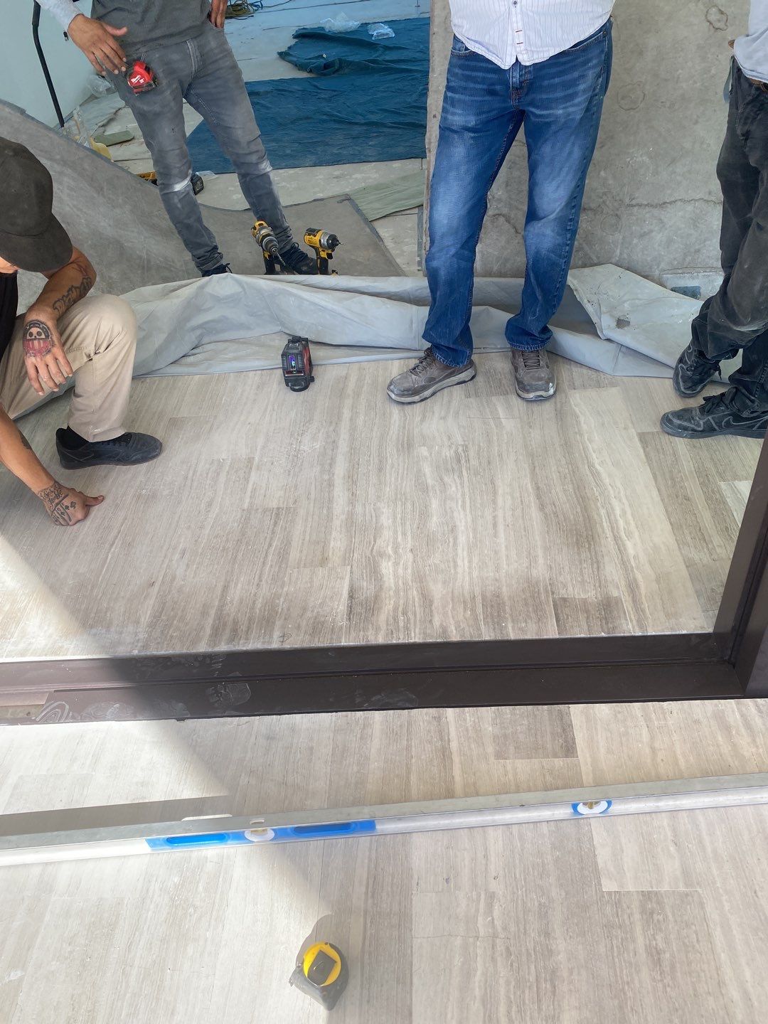 Custom Material Pivot Door installation by Impact Precious Wood Inc.