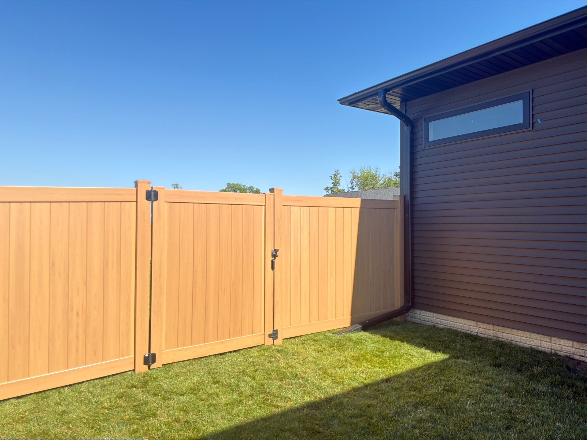 Residential Cypress Vinyl Privacy Fence Installation in Cedar Falls by Perfect Picket Fence and Stain