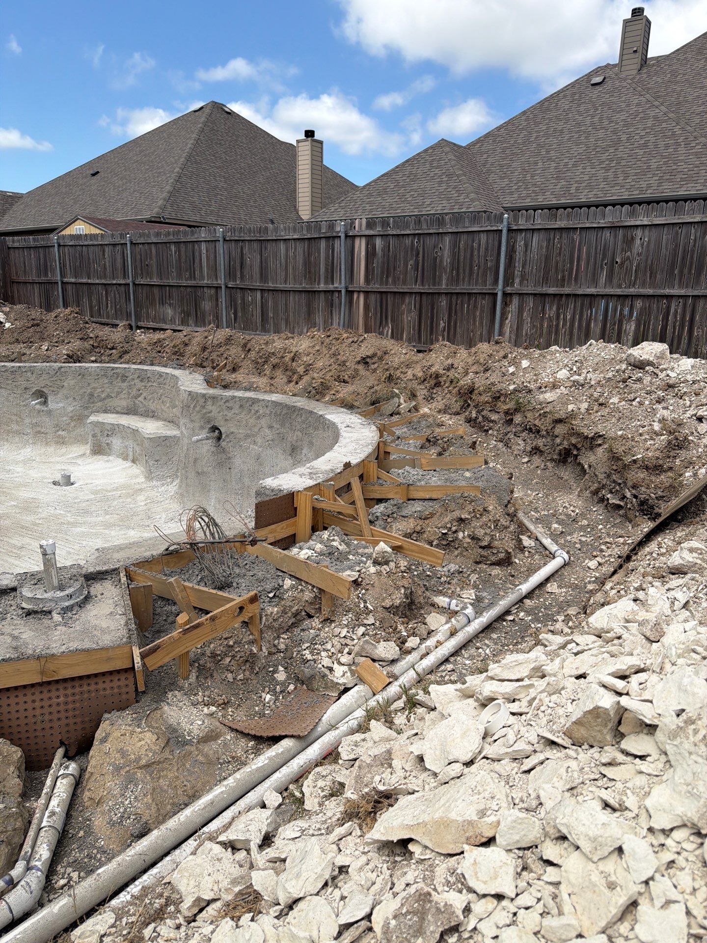 Freeform Pool with Tanning Ledge and Raised Stone Wall by Pinnacle Pools and Spas - DFW