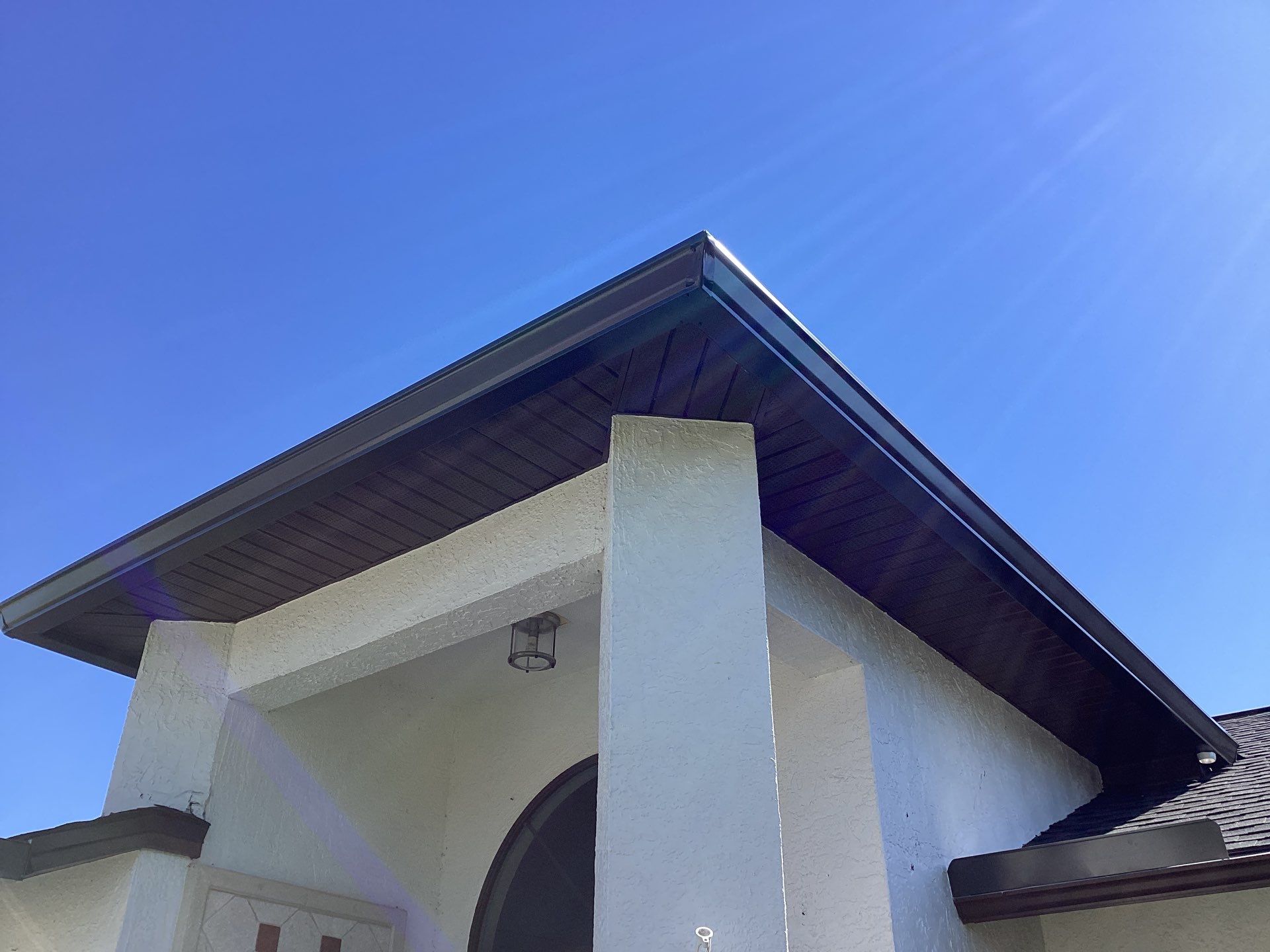Brown Gutter + White and Brown Downspouts in Cape Coral FL by Gutter Professors