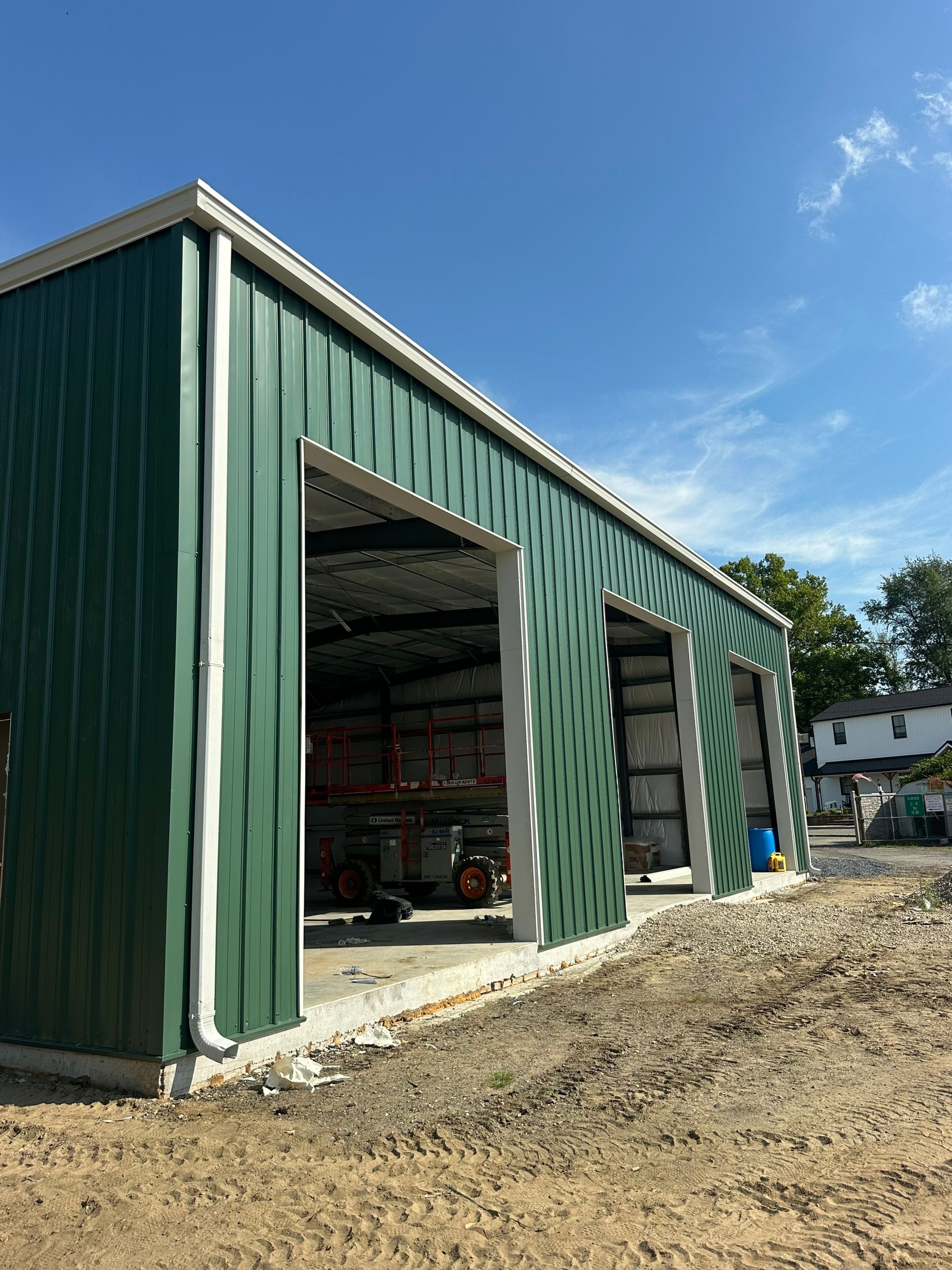 Dark Green Metal Siding by Reimagine Roofing