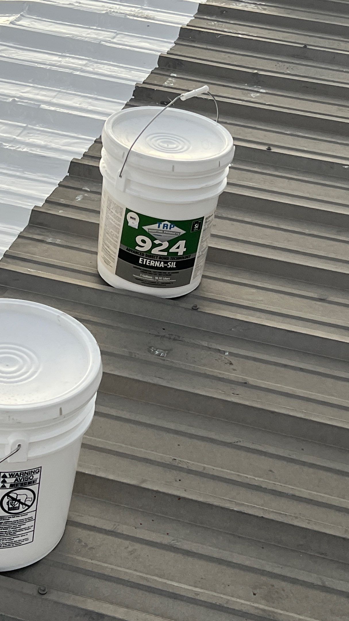 Commercial Roofing Installation using TRP #924 Eterna-Sil Premium Silicone Roof Coating by Harvey Roofing & Construction