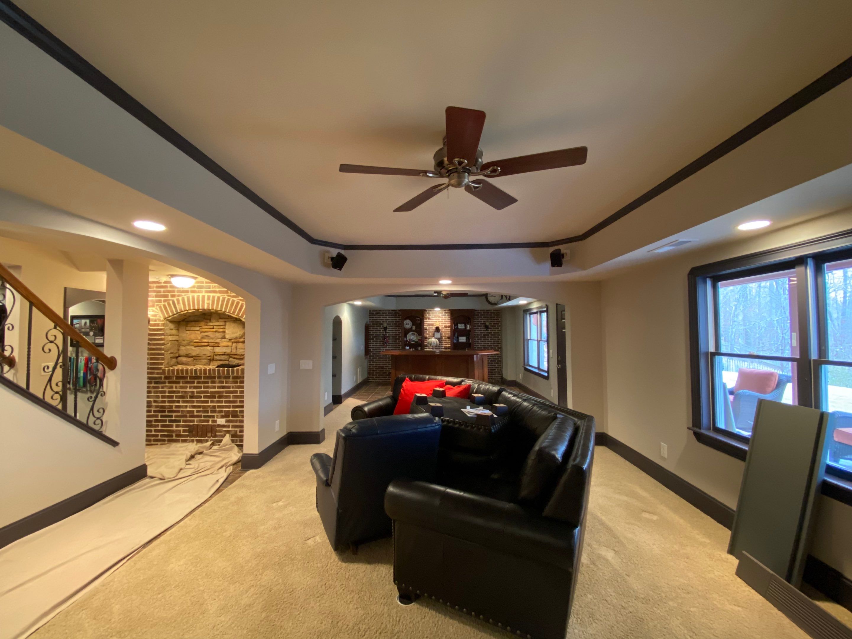 Finished Basement Renovation with Custom Shiplap and Modernized Wood Railings by Swift Home Renovations 