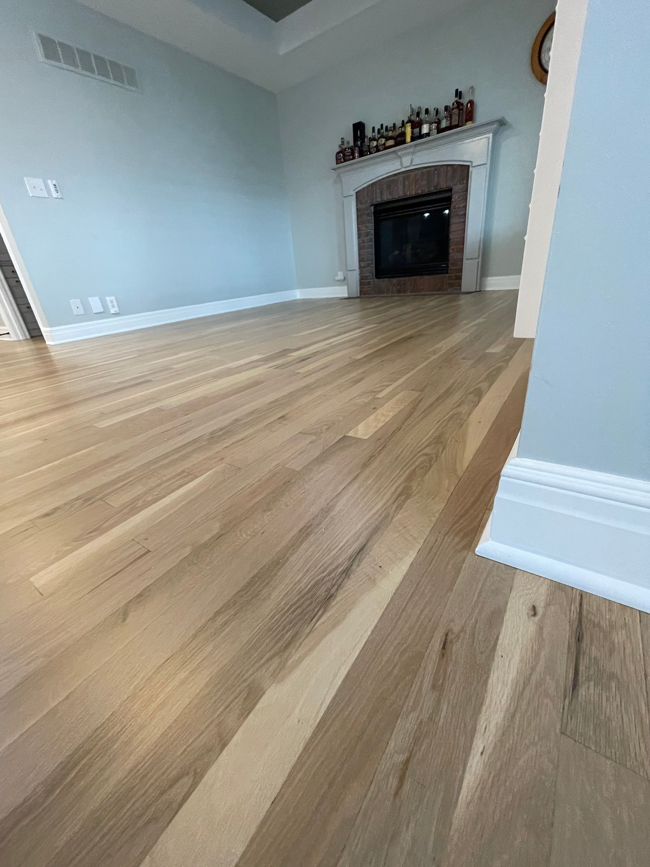 Hardwood Flooring Installation and Baseboard Trim in Grain Valley by Rippnfinish