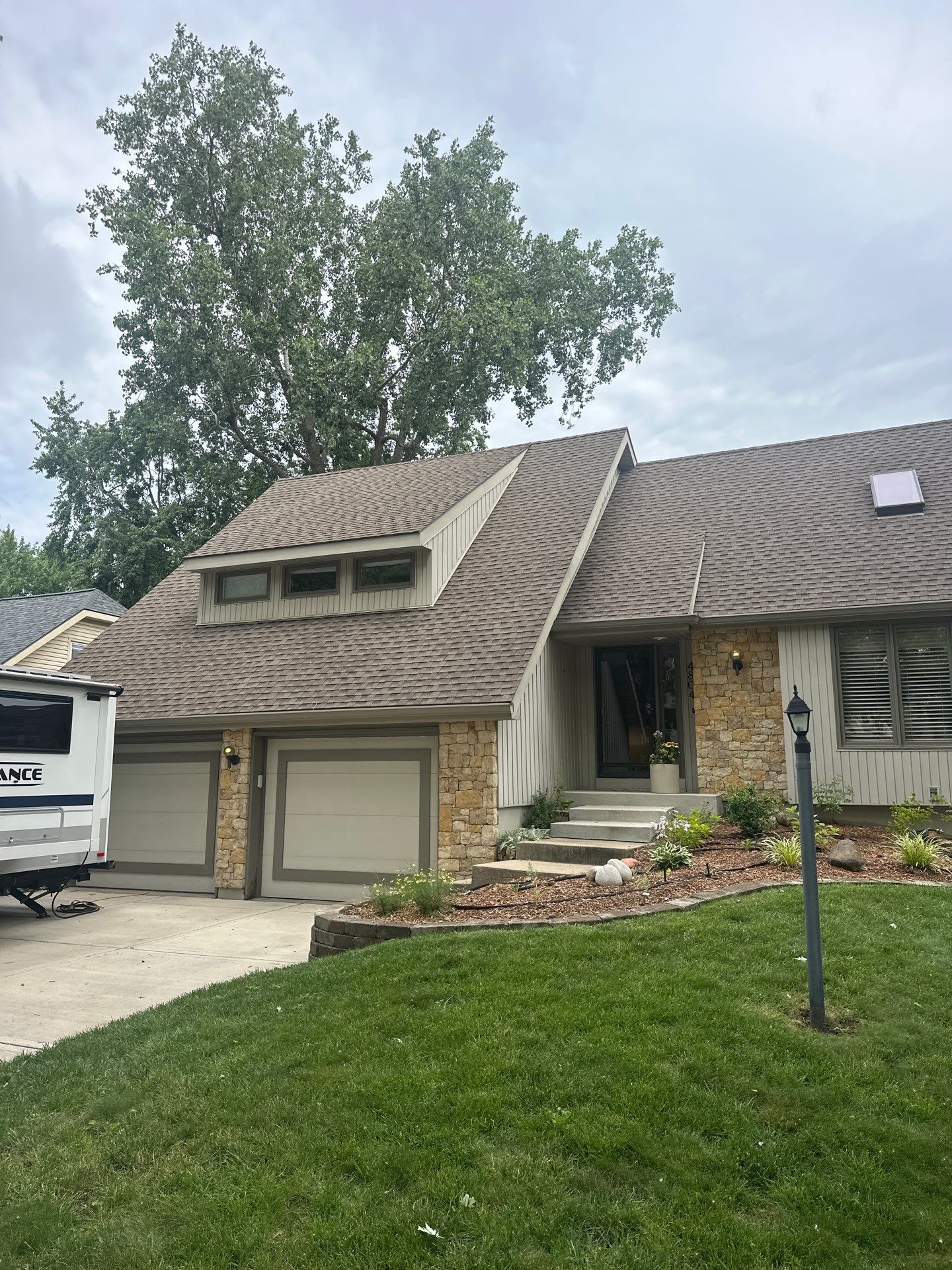 Comprehensive Kansas City Exterior Remodel Featuring Board And Batten Siding by EEC Windows, Siding & Roofing