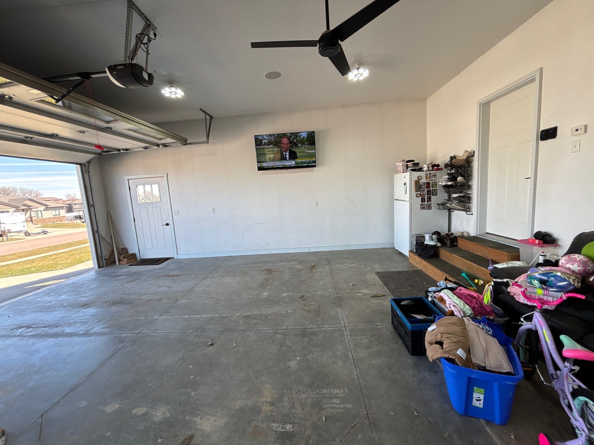 Speckled Polyaspartic Garage Floor Coating Installation in Dell Rapids by Select Painting, Coatings & Garage Cabinets