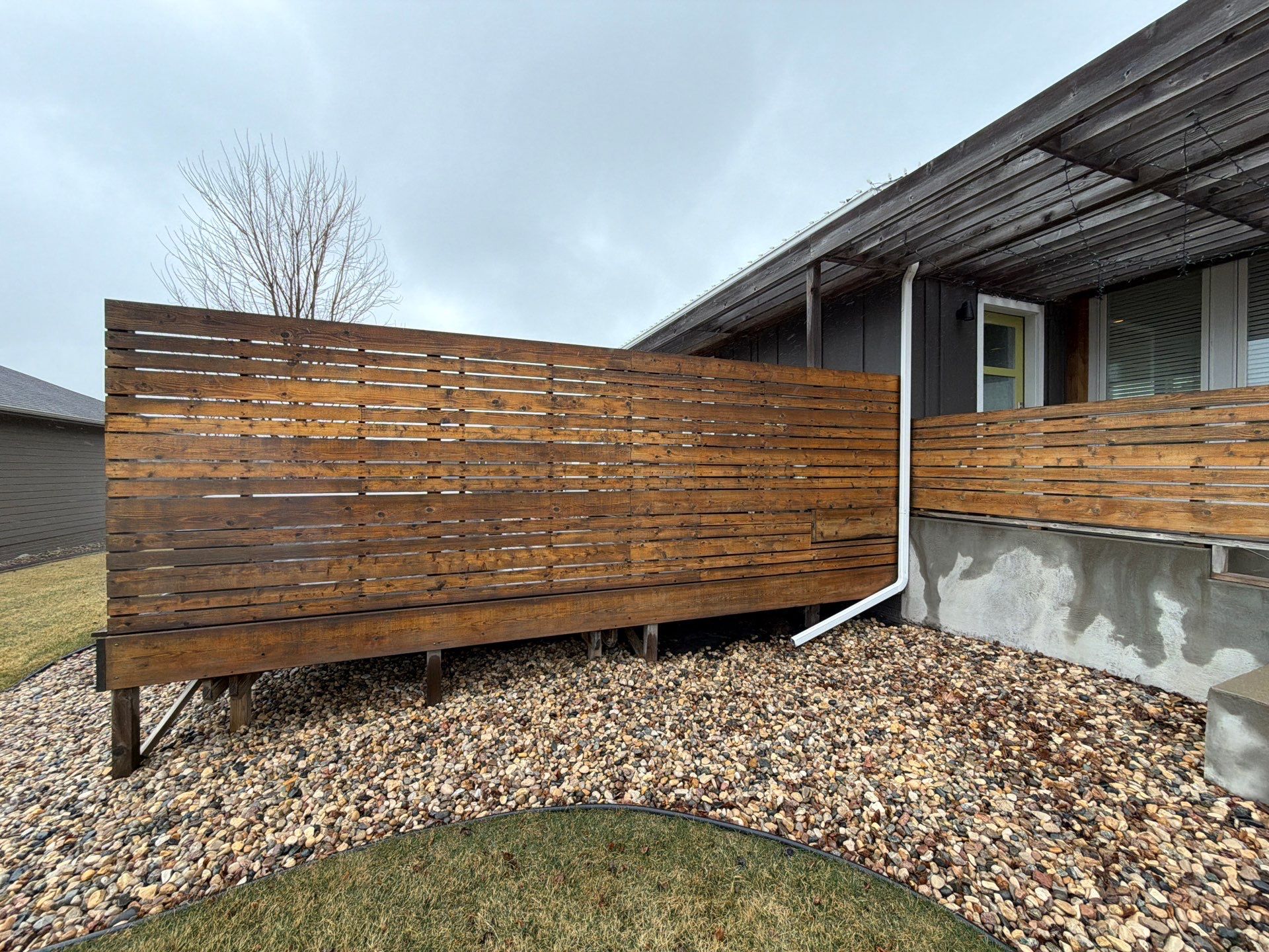 Modern Exterior Transformation Featuring Dark Board and Batten Siding in Sioux Falls by Select Painting, Coatings & Garage Cabinets