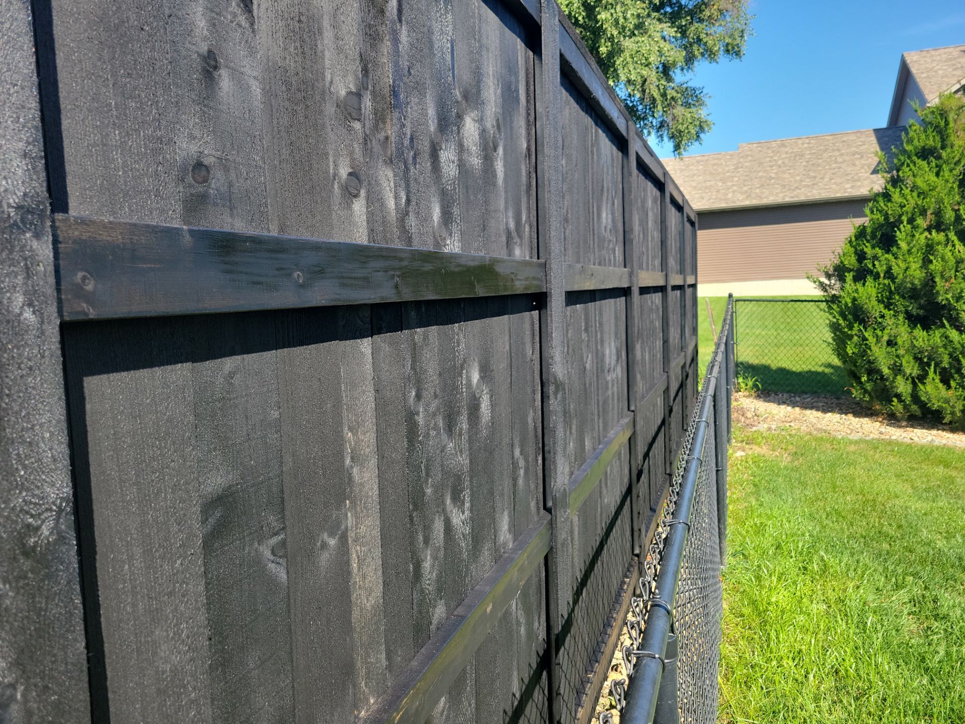 Black Wood Privacy Fence in Cedar Falls by Perfect Picket Fence and Stain