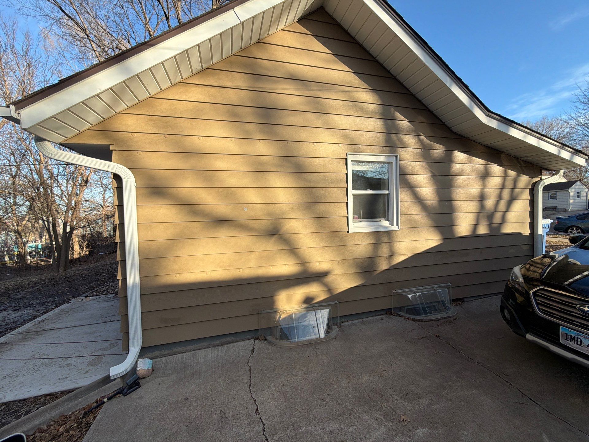 Exterior Siding Repair and Full House Repaint in Sioux Falls by Select Painting, Coatings & Garage Cabinets