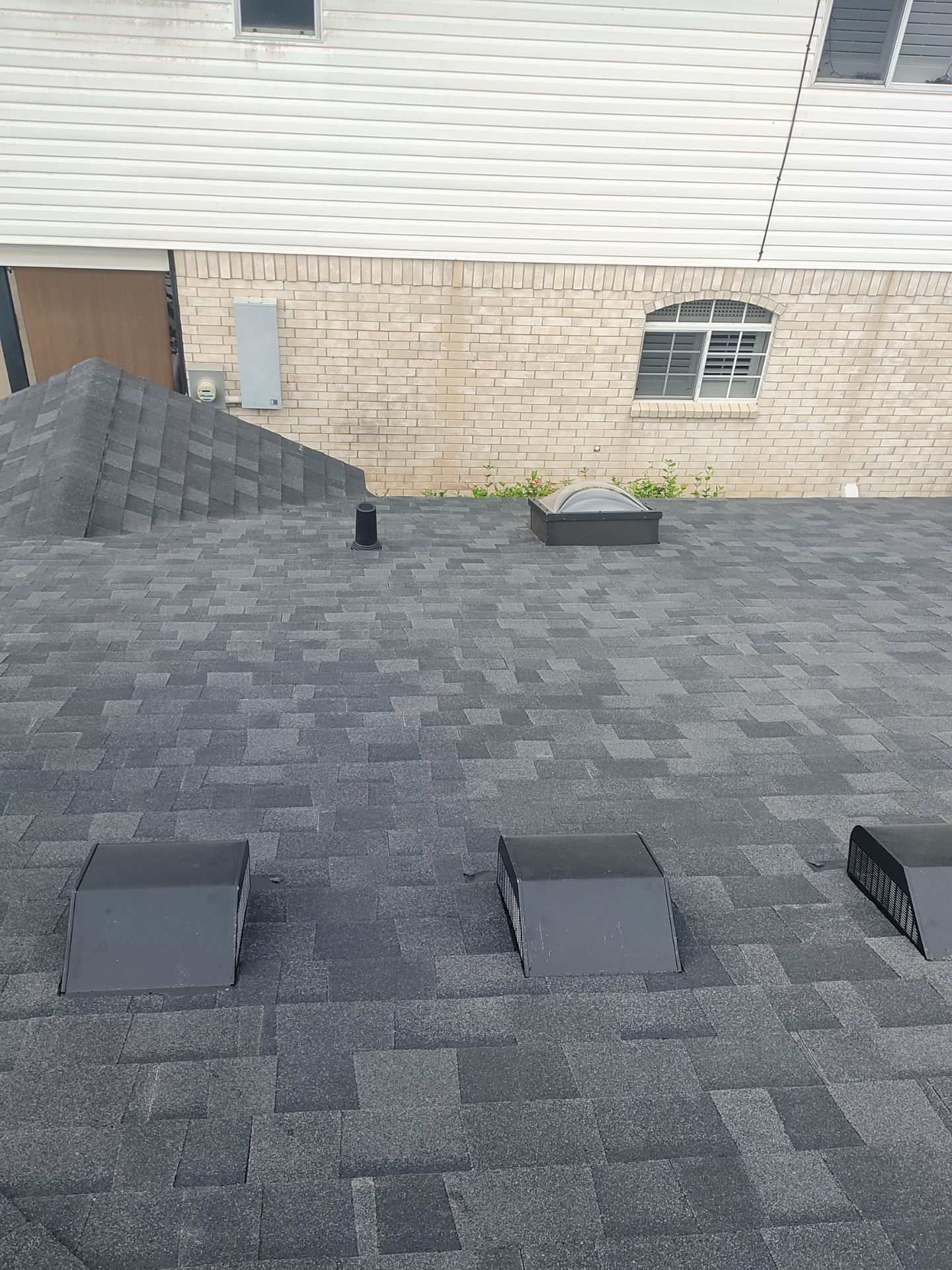 Nothing looks nicer than a little black roof by Bayfront Roofing and Construction