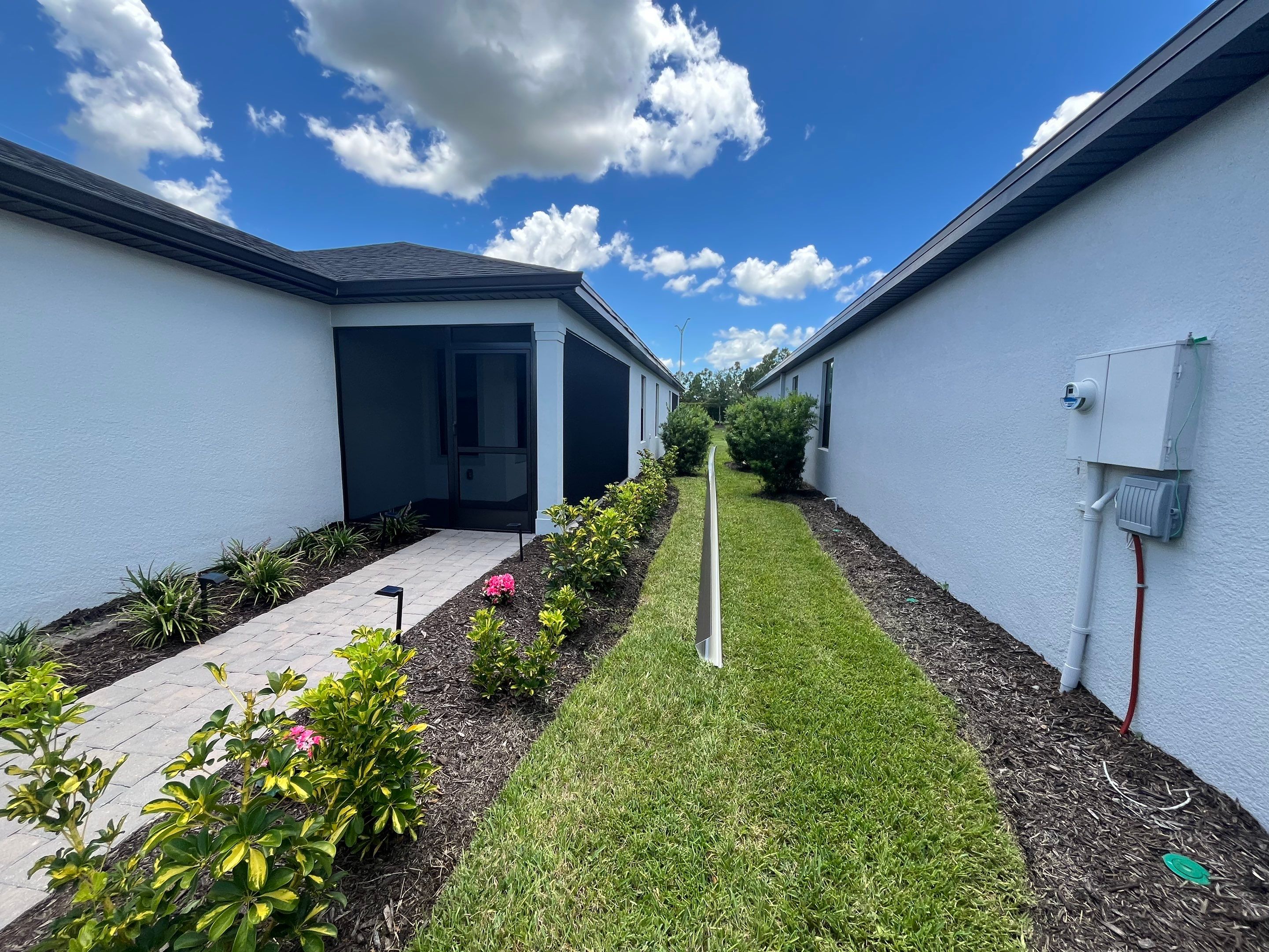 Dark Bronze Gutters and White Downspouts in Sarasota FL by Gutter Professors