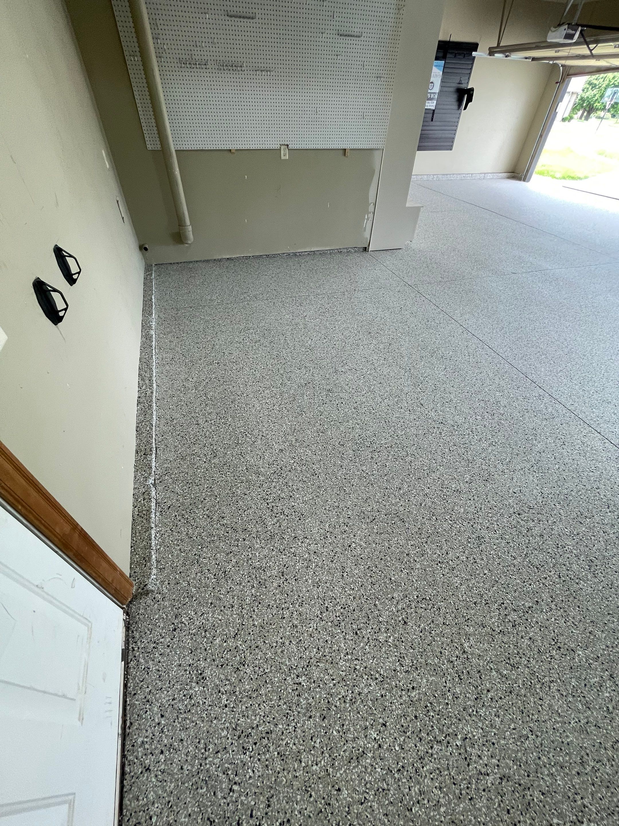 Cabin FEver Flake Garage Floor Coating Installation in Sioux Falls by Select Painting, Coatings & Garage Cabinets