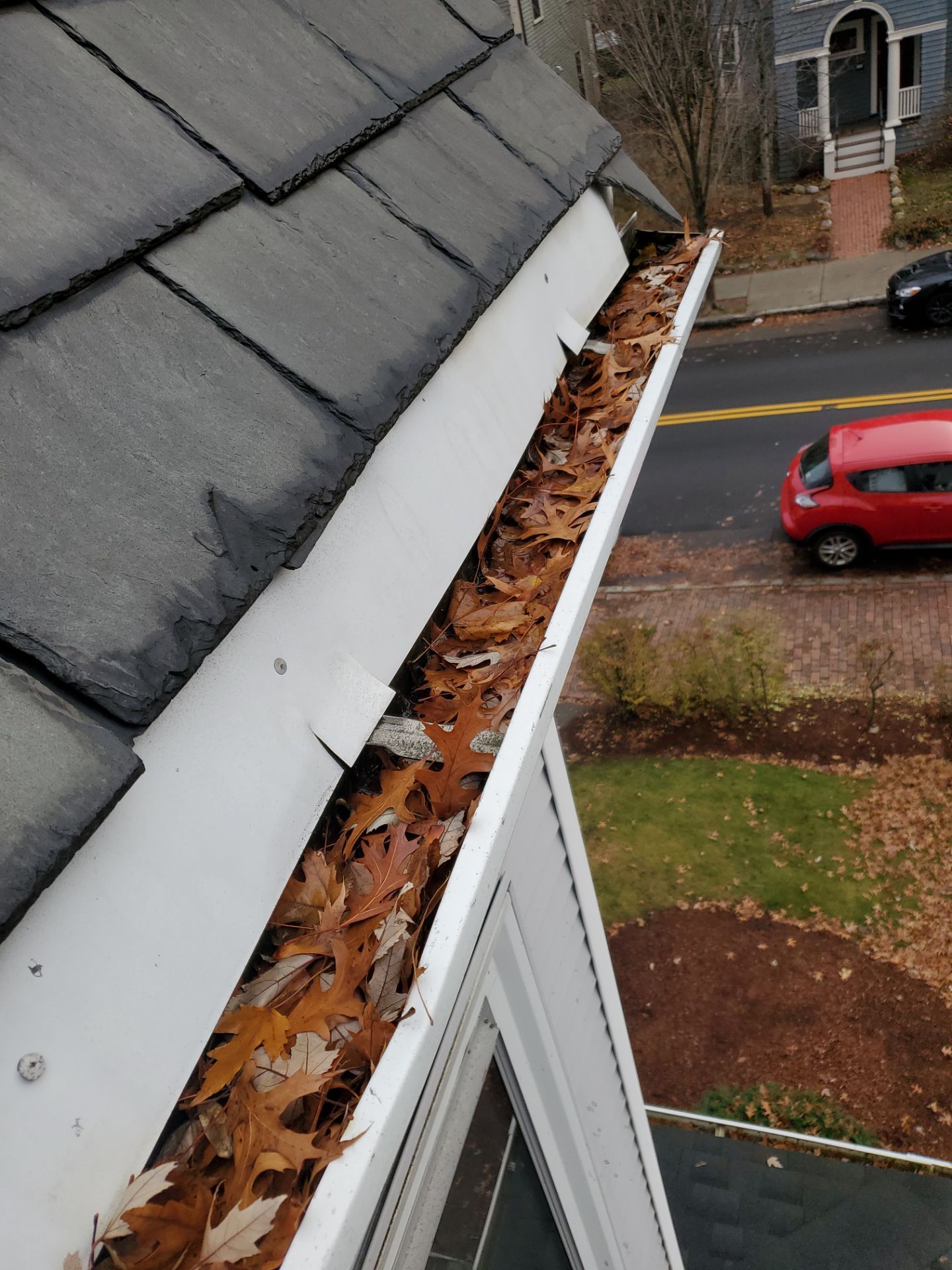 Commercial gutter cleaning Massachusetts before photo with filled gutters