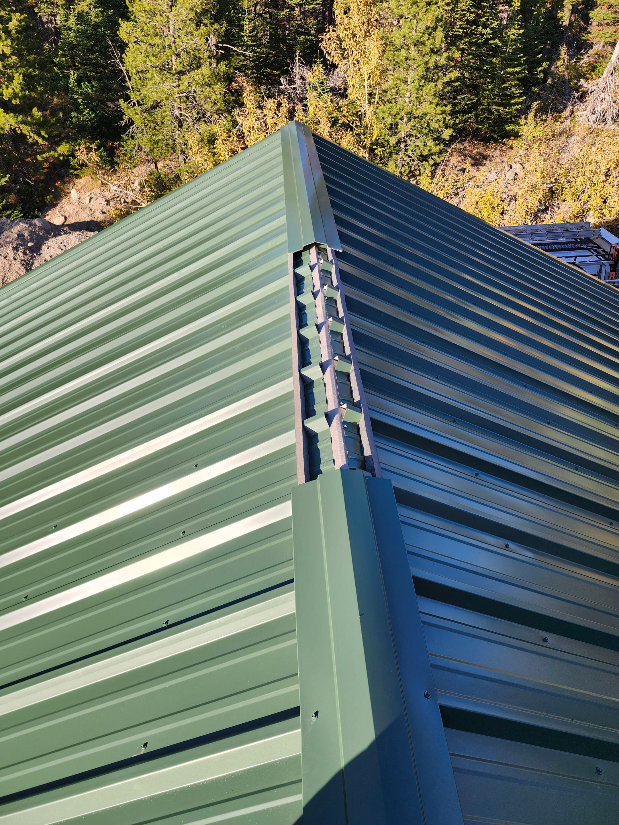 Green Standing Seam Metal Roof Installation in East Glacier Park by KQC Roofing