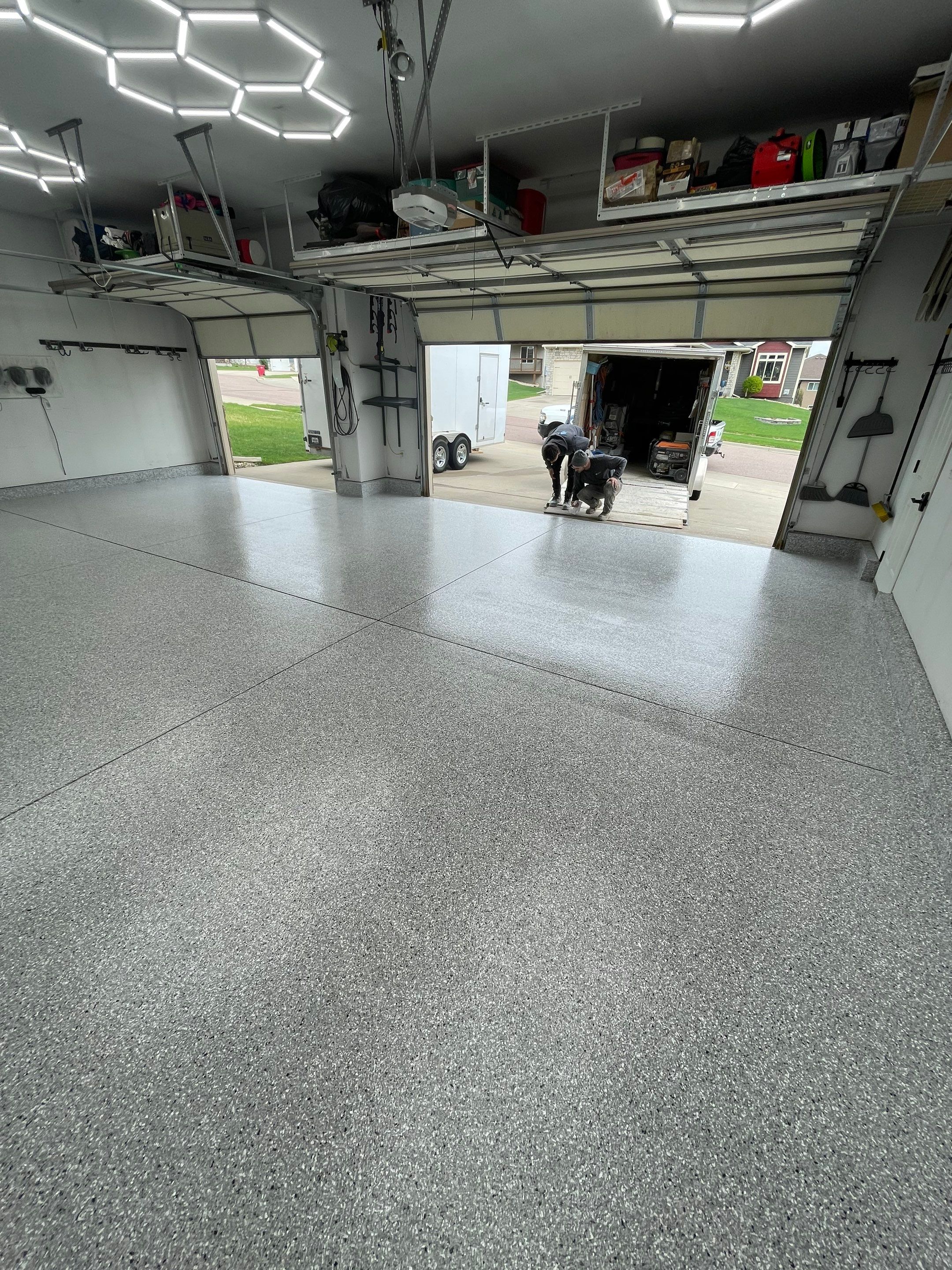 Feather Gray Epoxy Floor Coating Installation in Sioux Falls by Select Painting, Coatings & Garage Cabinets
