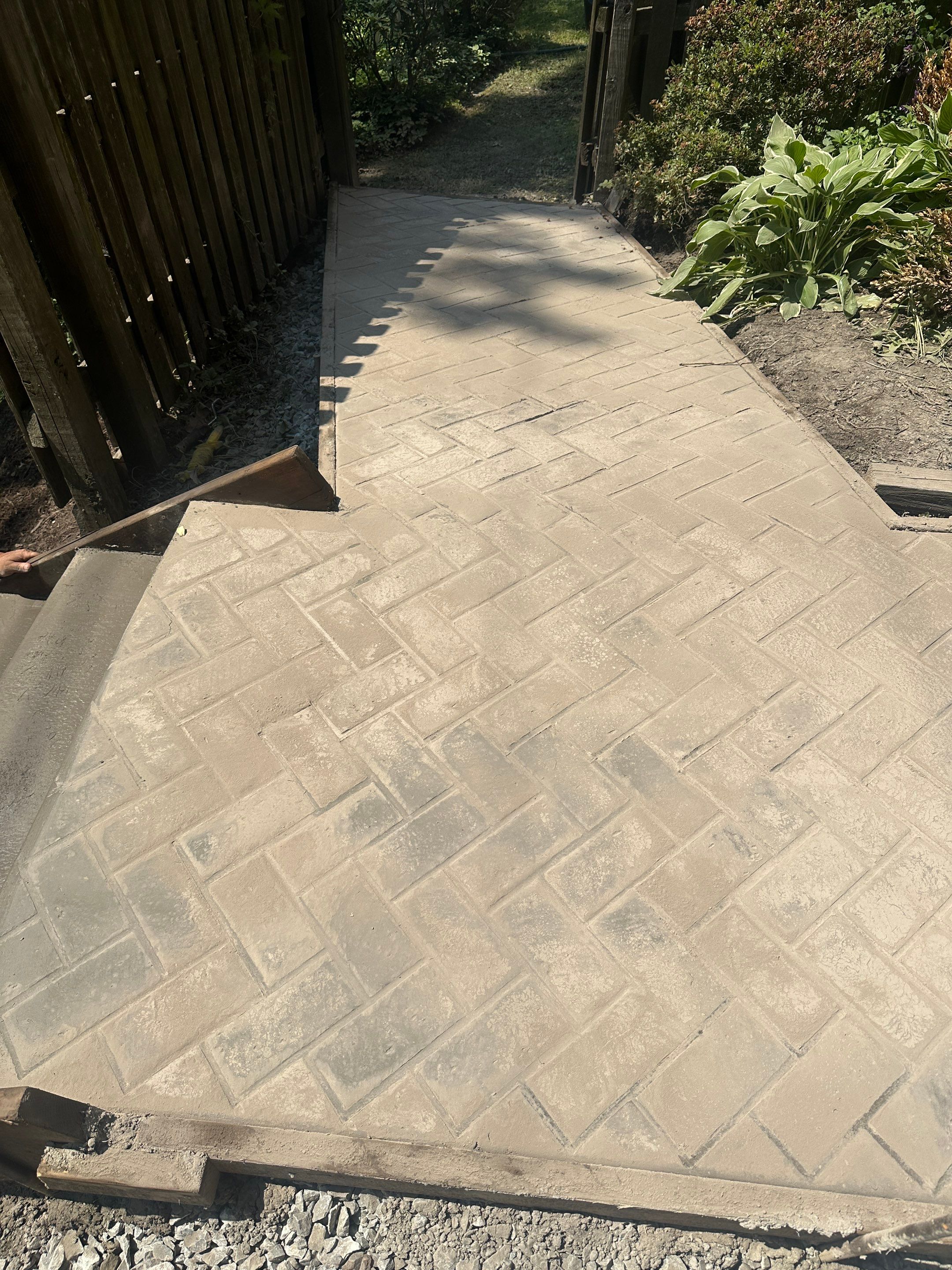 Stamped Concrete and Retaining Wall by Cousins Roofing Siding & Decks