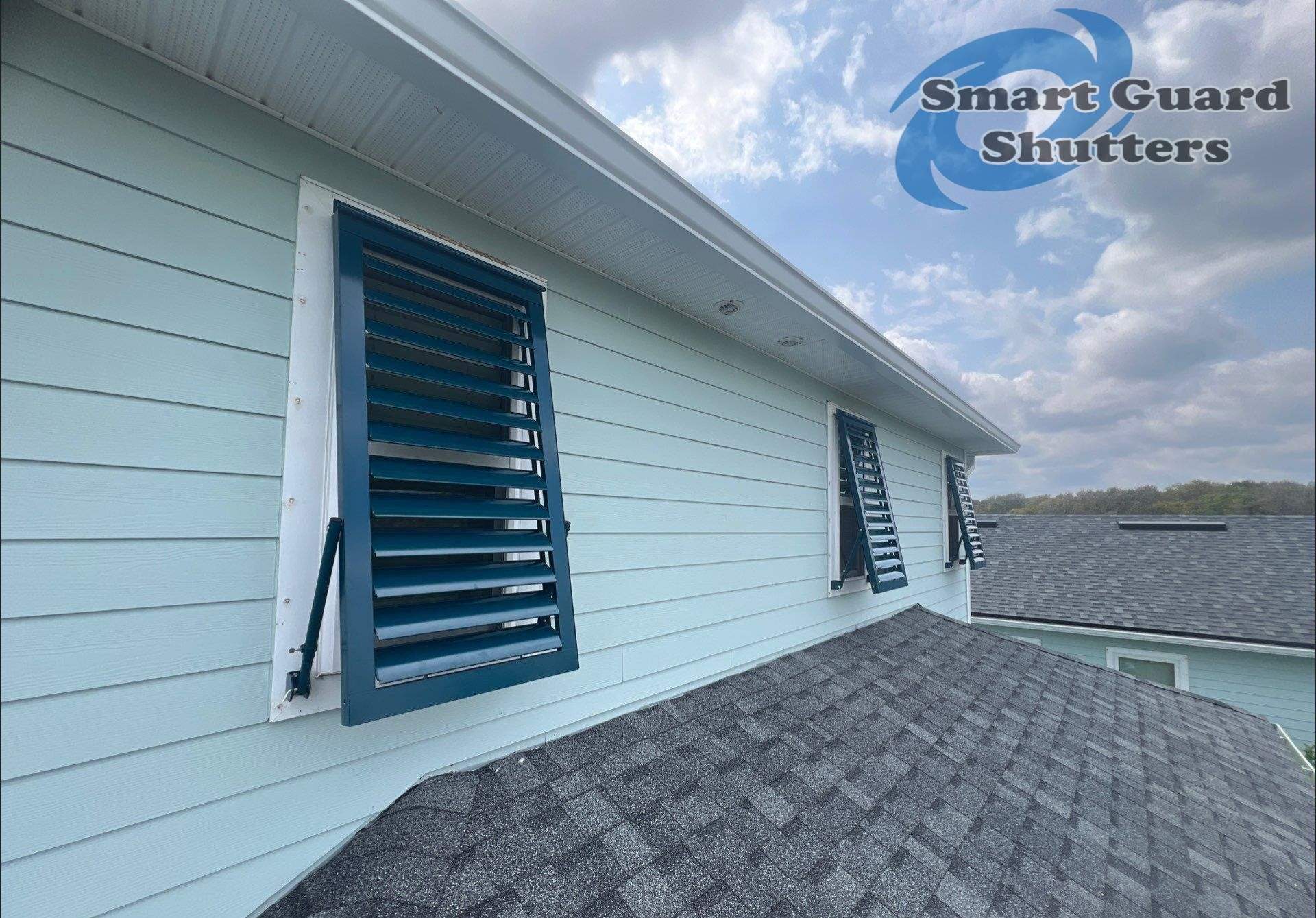 Impact Bahamas in Ocean Blue, Accordion in White by Smart Guard Shutters